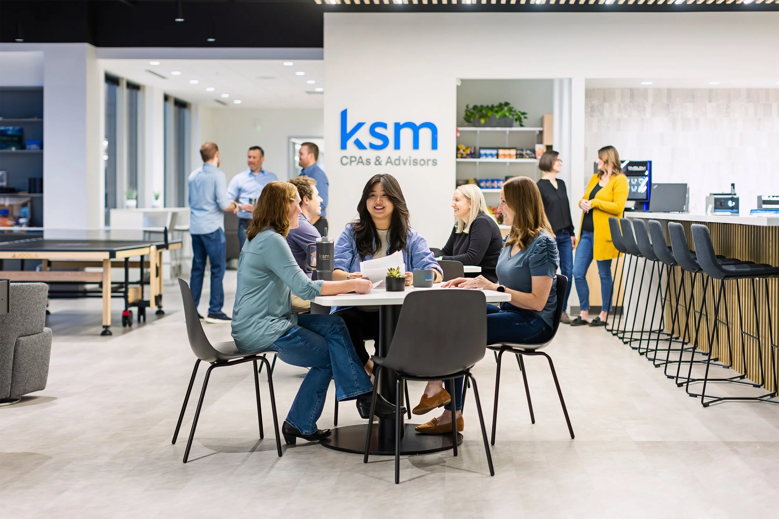 KSM team members gathered around tables in their office café, Indianapolis brand photography