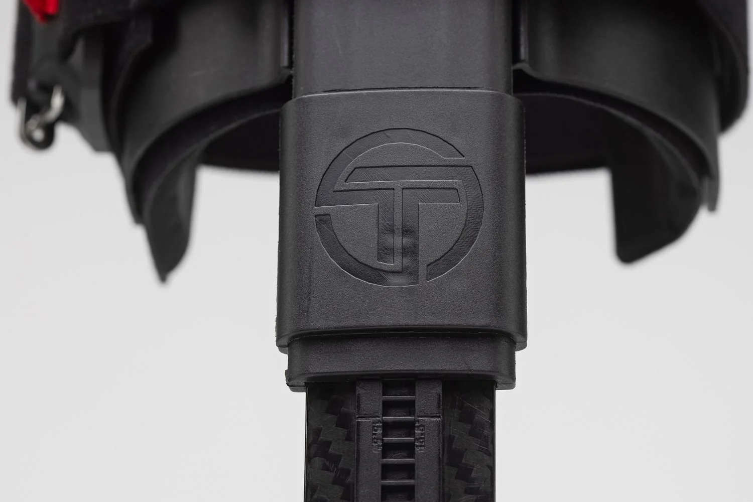 Close-up of the Thrive Orthopedics logo on a black brace strap, detail product photography