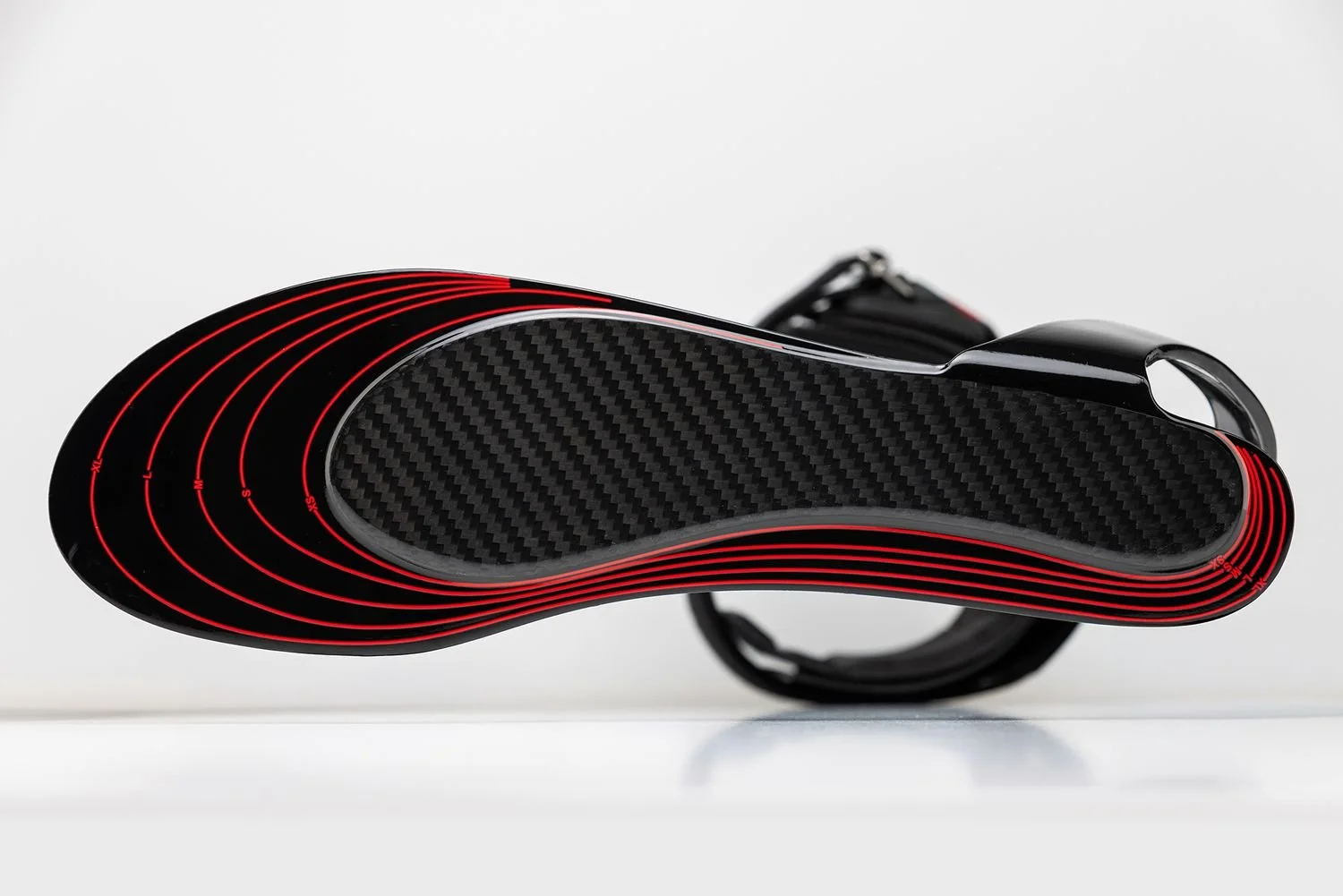 Carbon-fiber footplate with red layered edges, Thrive Orthopedics product photography