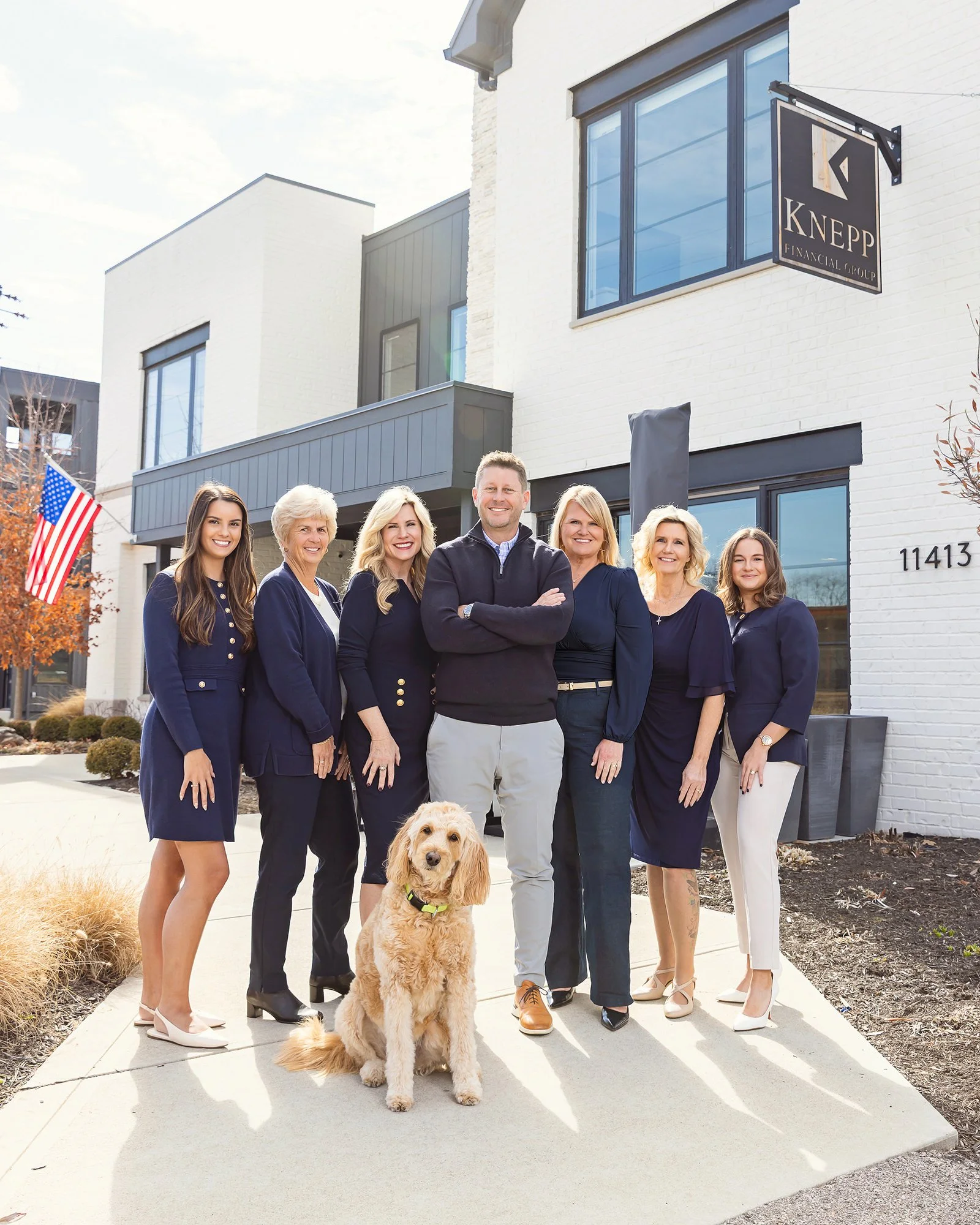 Knepp Financial team posing with a golden retriever outside their office, Central Indiana team photo