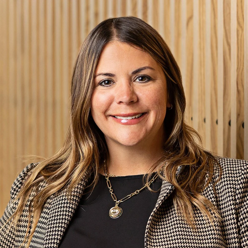 Jamie Pike of KSM Location Advisors smiling in a houndstooth blazer, professional headshot