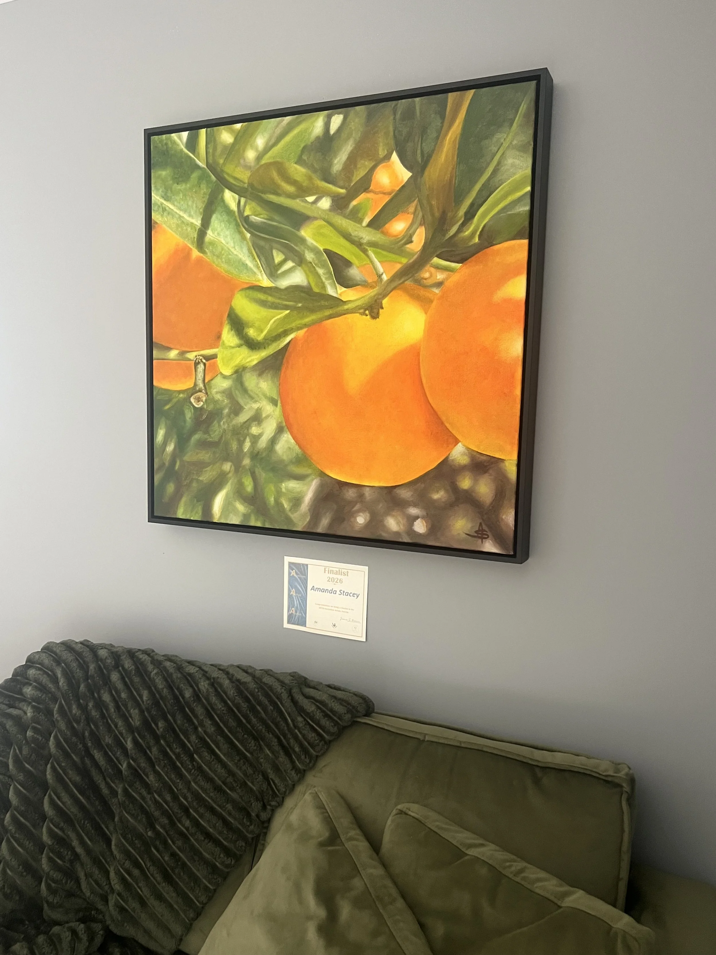 Abundance original oil painting by Amanda Stacey, viewed from an angle to show the canvas surface and black timber frame