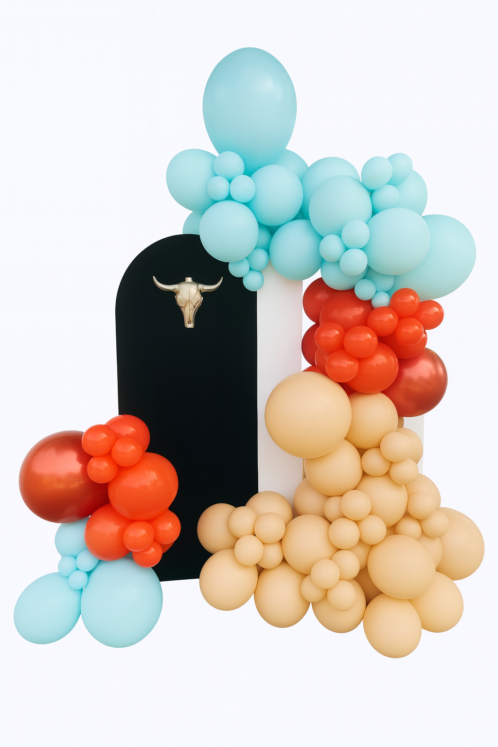 Colorful balloon arrangement with pastel blue, peach, and red balloons, a black arch with a gold bull skull decoration, against a white background.