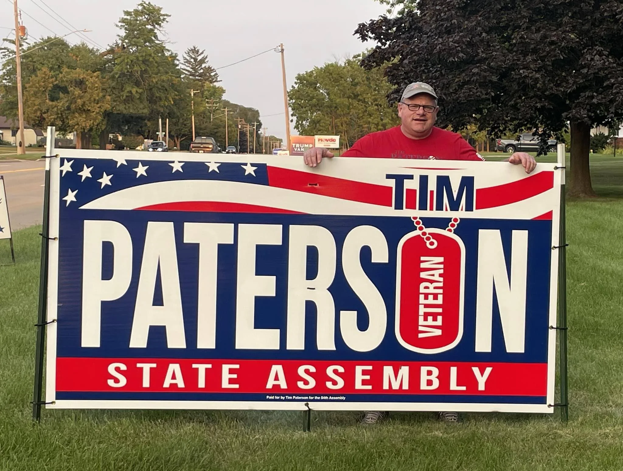 Tim posing with an oversized yard sign for his state assembly campaign.