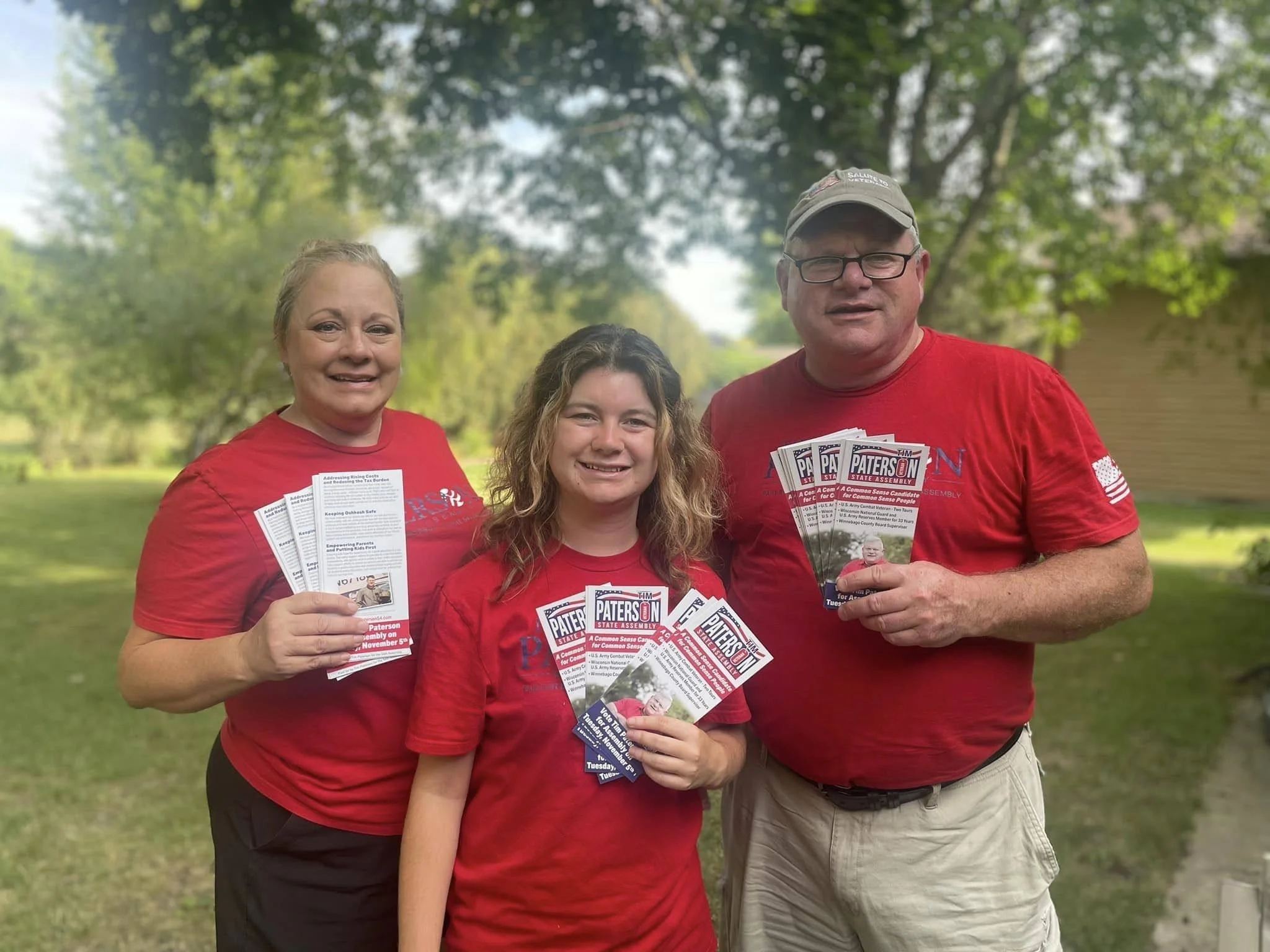 Tim, Joan, and their daughter with campaign literature.