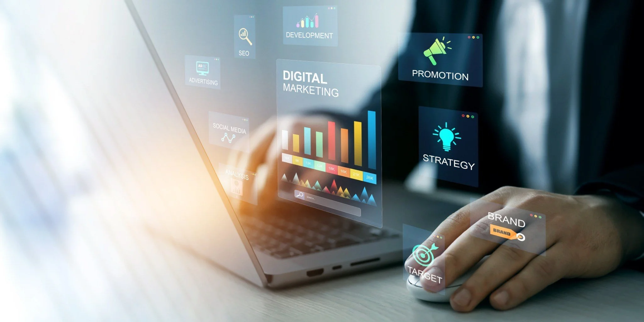 Digital marketing concept with holographic icons displaying marketing strategies such as SEO, social media, advertising, development, promotion, strategy, brand, and target, projected over a person's hand and a laptop.