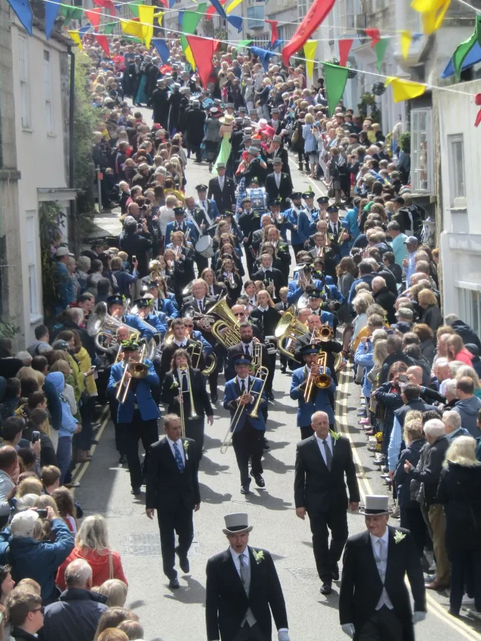 The early Jacaranda Festivals were loosely inspired by the springtime event held in Helston, Cornwall UK. Three dances are held in the streets of the village throughout the day. The entire community dances as it progresses through the narrow lanes of