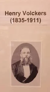 Text about Henry Volckers (1835-1911) with a black and white portrait photograph of him below.