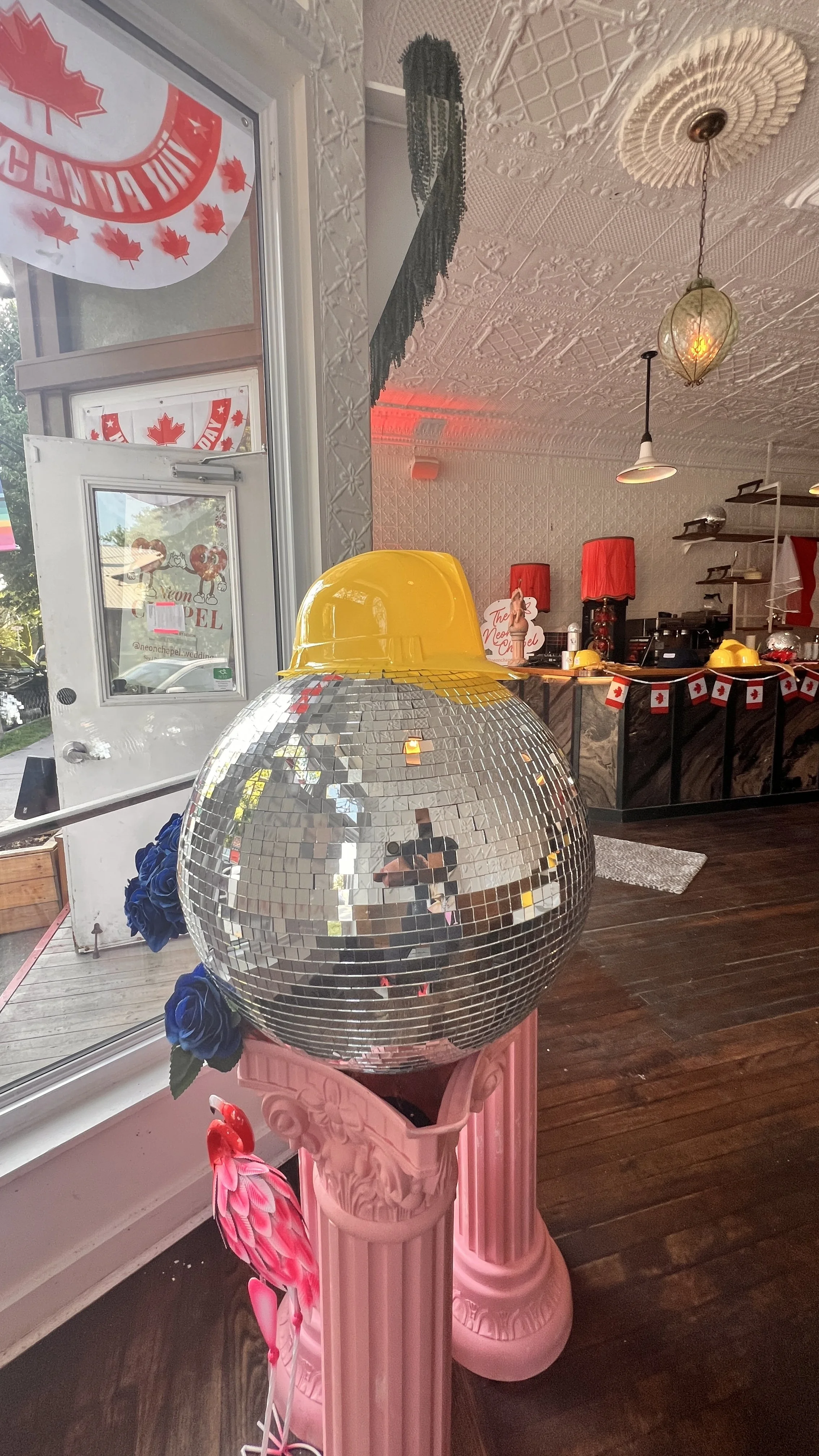 Disco ball and Canada-themed party decor inside The Neon Chapel, a Prince Edward County wedding venue.