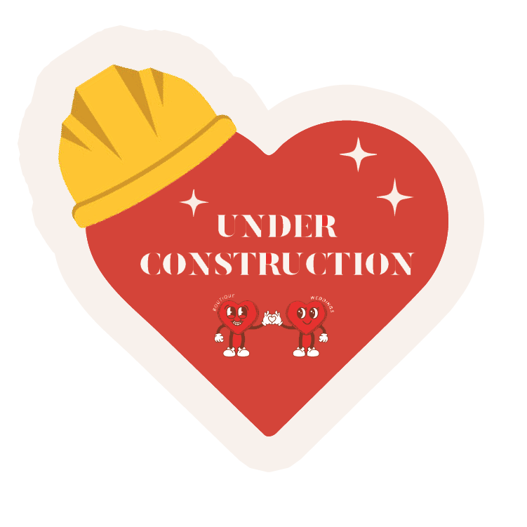 A heart-shaped construction sign with a yellow hard hat and cartoon hearts holding hands, reading 'Under Construction' in the center.