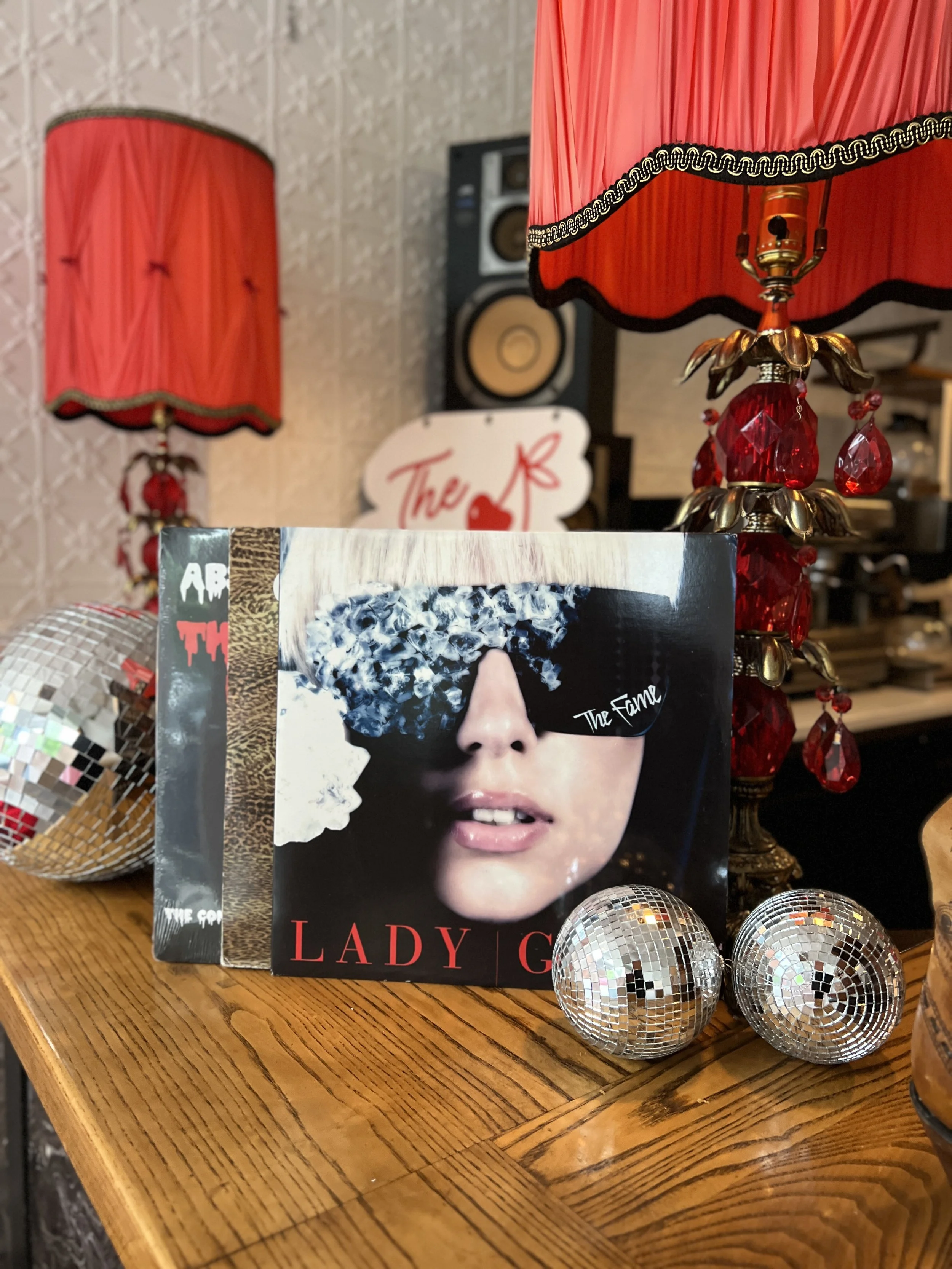 Retro disco-lounge decor at The Neon Chapel wedding venue in Prince Edward County, featuring a Lady Gaga magazine and disco ball ornaments.