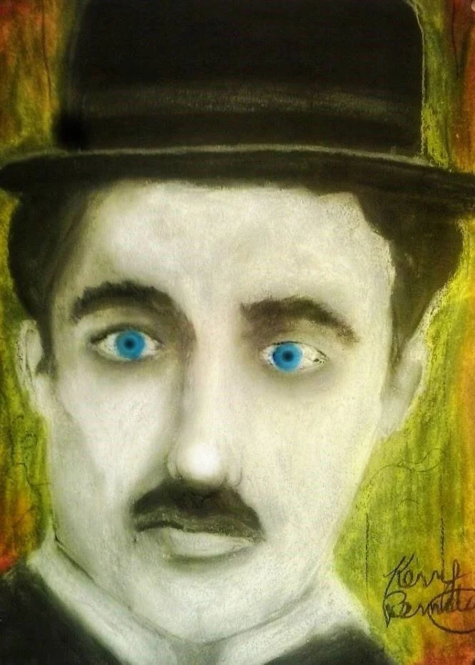 Charlie Chaplin as The Tramp — Oil Pastel Portrait  
This oil pastel portrait reimagines Charlie Chaplin’s Tramp with soft, impressionist strokes that blur the line between character and myth. The colours are rich and textured, capturing the worn ele