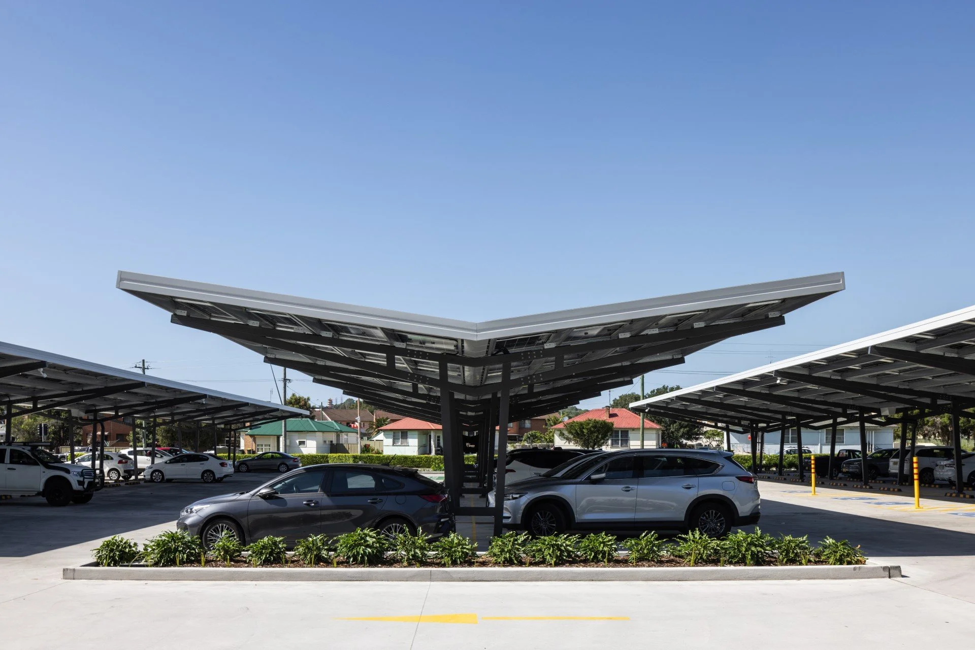 Canyon Series Solar Canopy. Modular wing canopies in two configurations. The system that powers Wests Illawarra, Woolworths and IGA Baranduda. Built around individual parking bays.