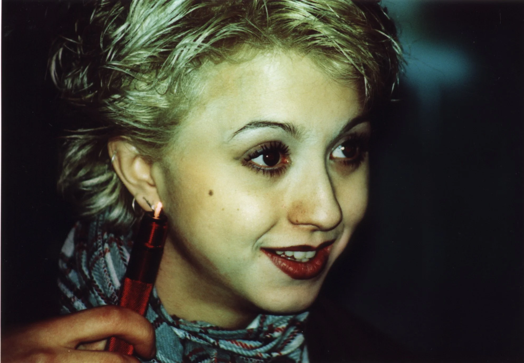 Independent film actress Katie Nisa setting focus mark with mag-lite flashlight on set of punk indie movie 'Threat' in 1998 New York City
