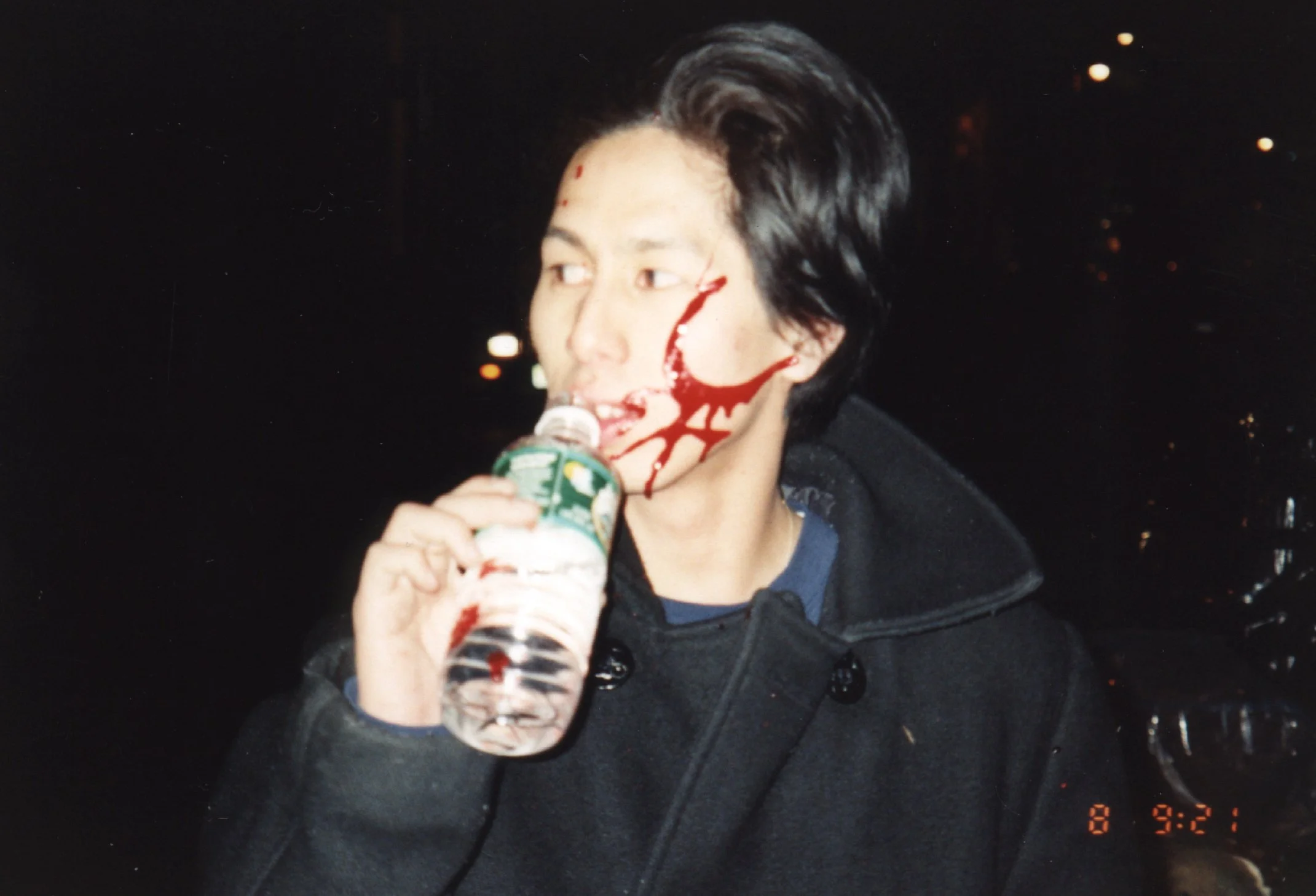 Candid photo of independent film actor covered in blood after horror scene special effects in punk indie movie 'Threat'