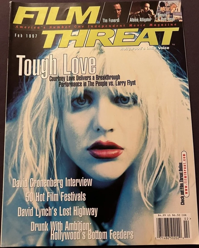 The cover of Feb 1997 issue of Film Threat magazine featuring a close-up photo of a woman with platinum blonde hair, red lipstick, and blue eyes. The magazine headlines mention topics like tough love, interview with David Cronenberg, film festivals, and Hollywood's bottom feeders.