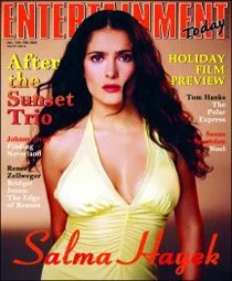 Entertainment Weekly magazine cover featuring Salma Hayek with long dark hair, wearing a yellow dress, with headlines about holiday movies, Sunset Trio, and Tom Hanks.