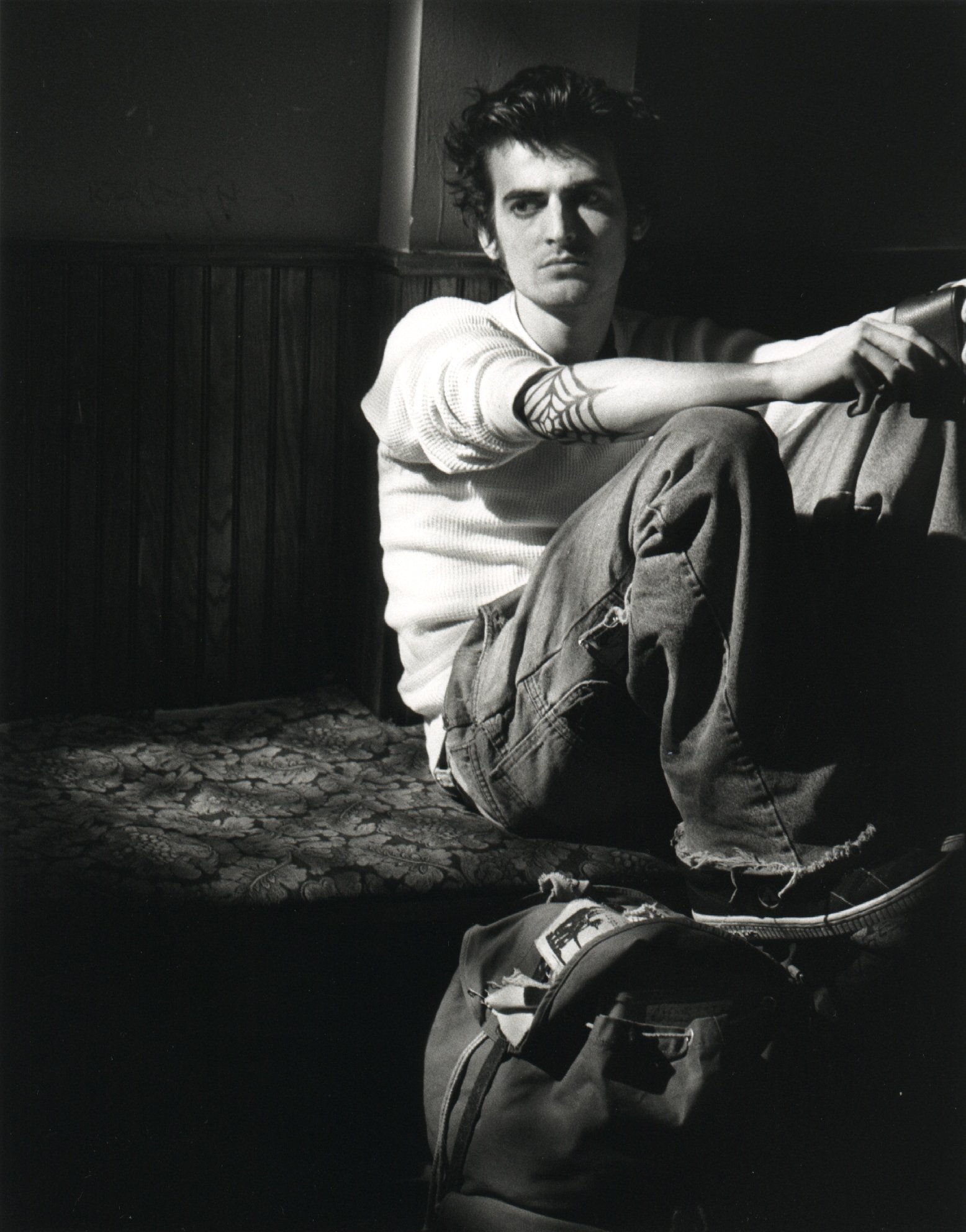 Independent film actor with webbed elbow tattoo on set during production of late-90s indie punk movie 'Threat'.