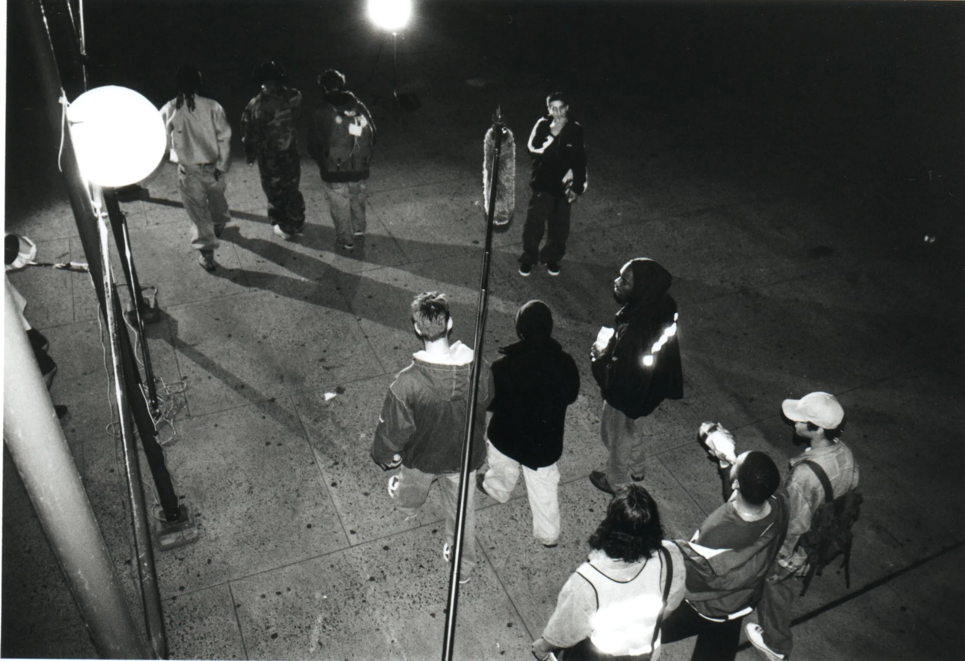 Independent film sound engineer holds boom over exterior night scene during production of late-90s NYC indie movie 'Threat'.