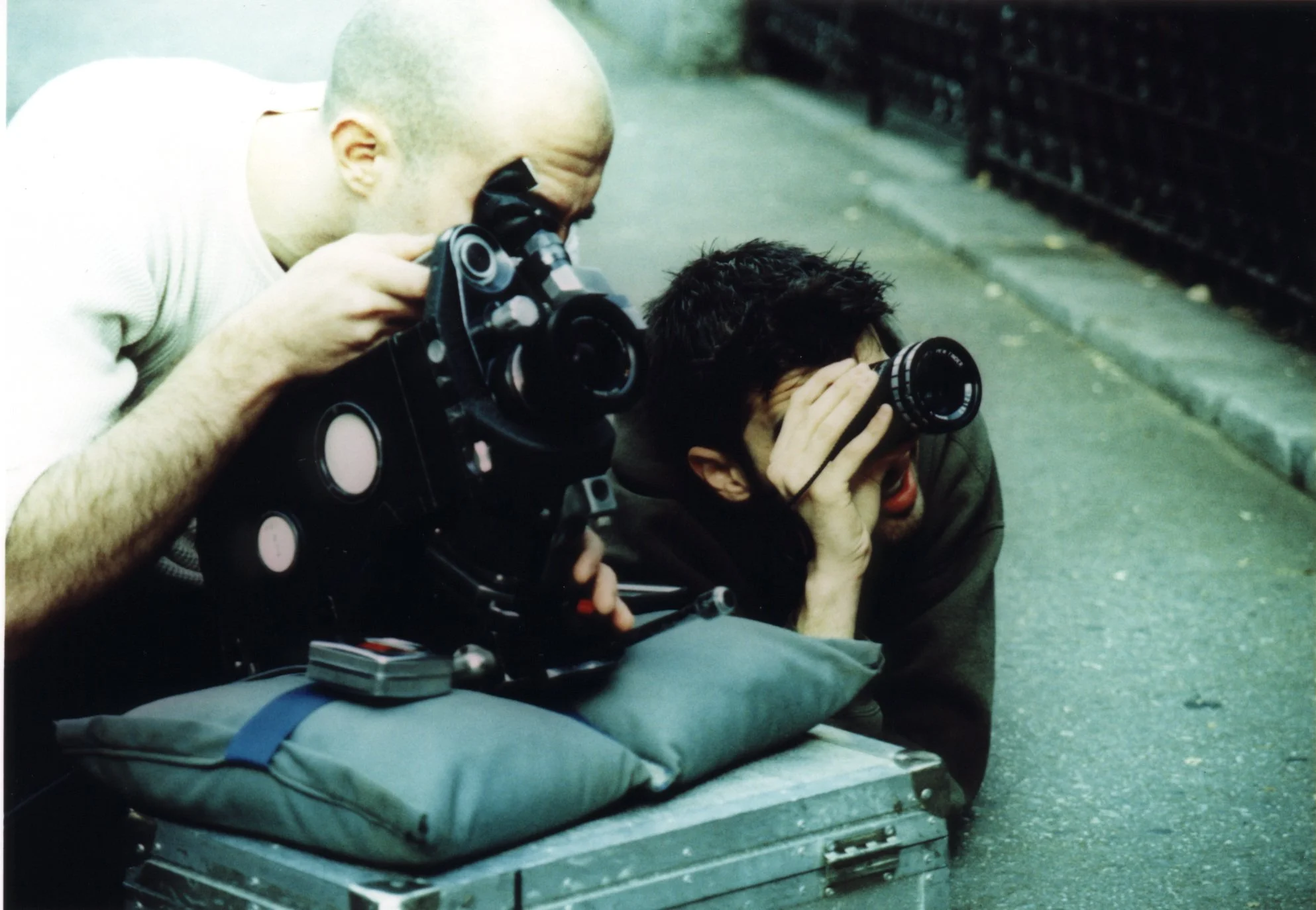 Independent filmmakers director Matt Pizzolo and cinematographer Ben Brancato with 16mm camera and director's eye device on-set of indie movie 'Threat' in late-90s New York City.