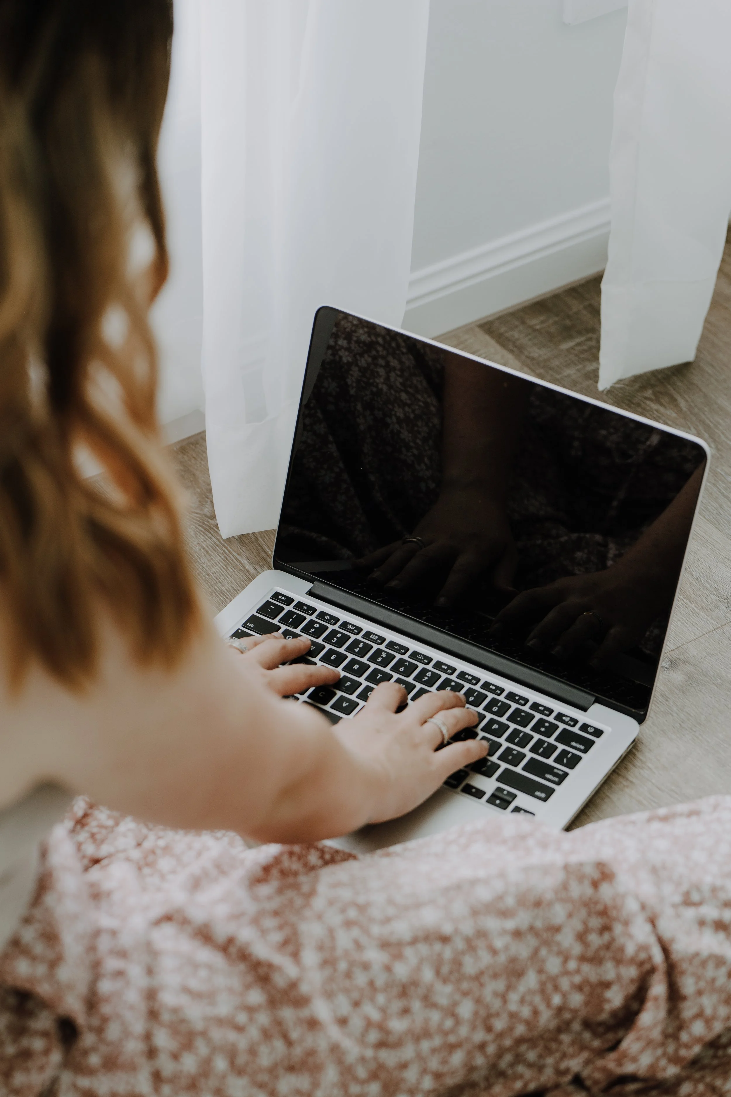 A woman on her computer.