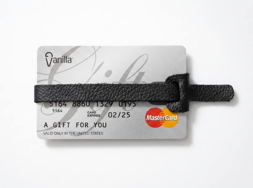Gift card with a black leather strap cover, displaying the Mastercard logo and expiration date, with the text "A GIFT FOR YOU" and "VALID ONLY IN THE UNITED STATES."