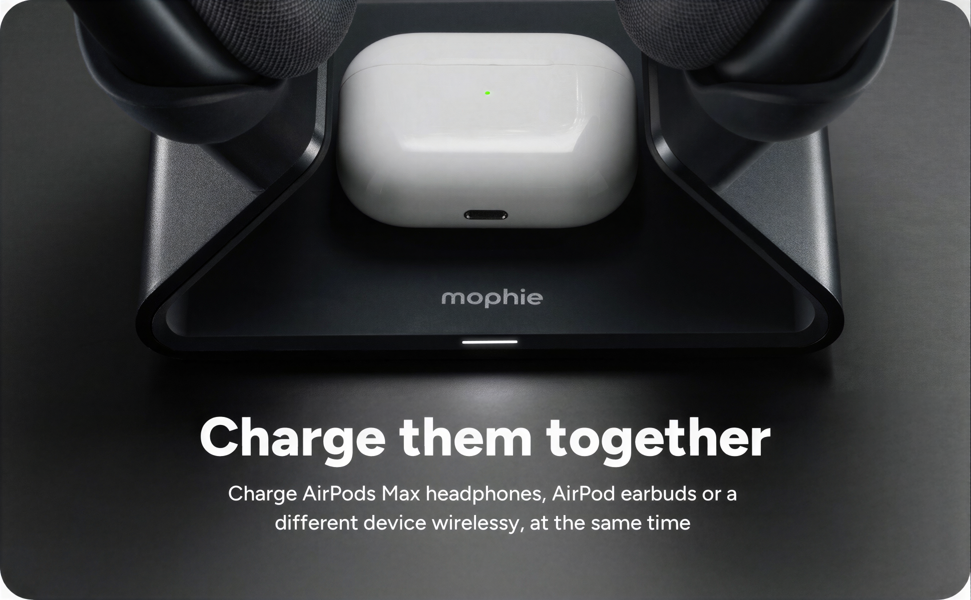 Top-down view of a wireless charging station with a white case of AirPods Max headphones on it, flanked by two black headphones on either side. Text overlay says "Charge them together" and enough of the smaller text is visible indicating charging Air