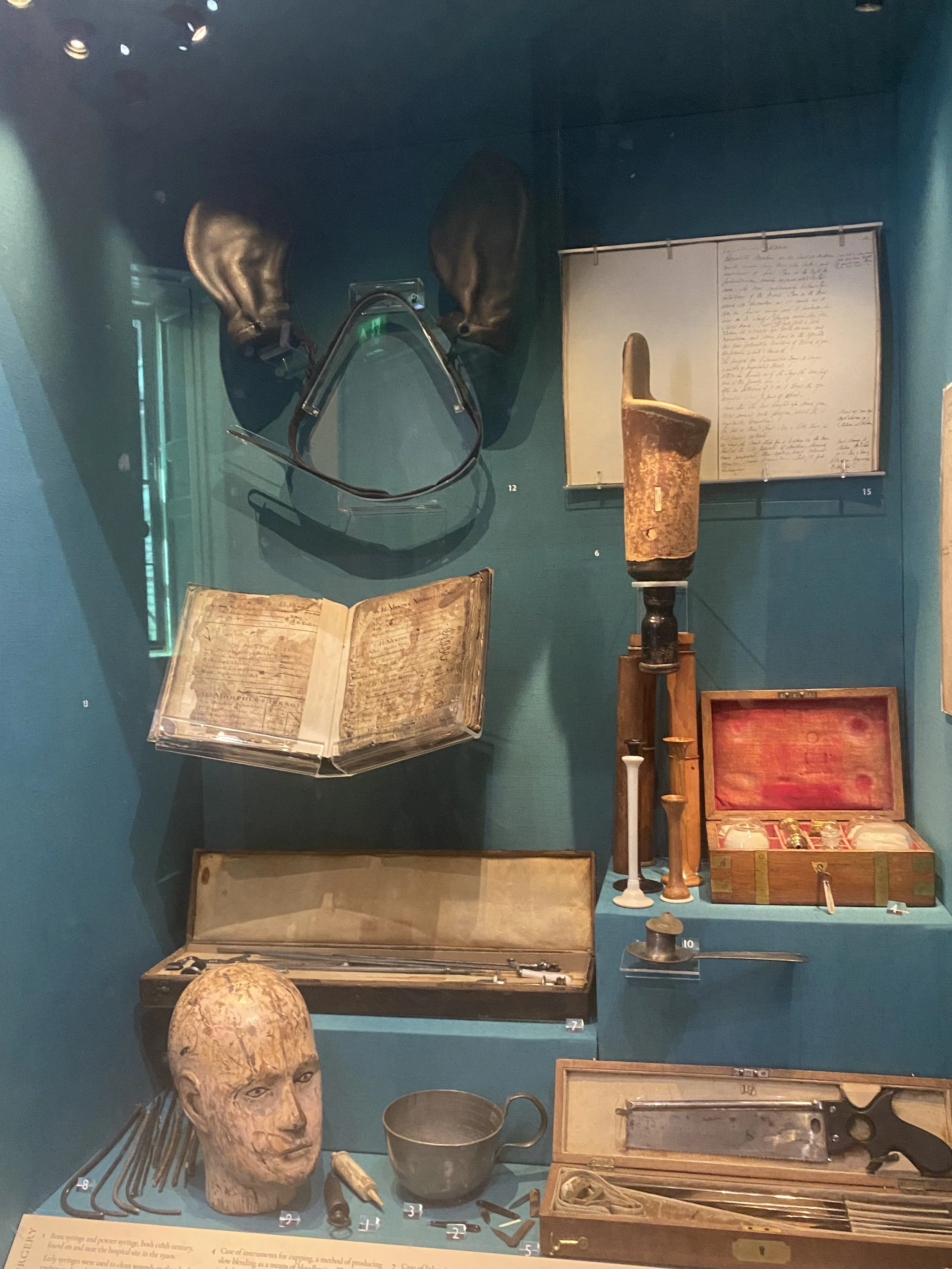 A glass case full of museum items related to medicine through time