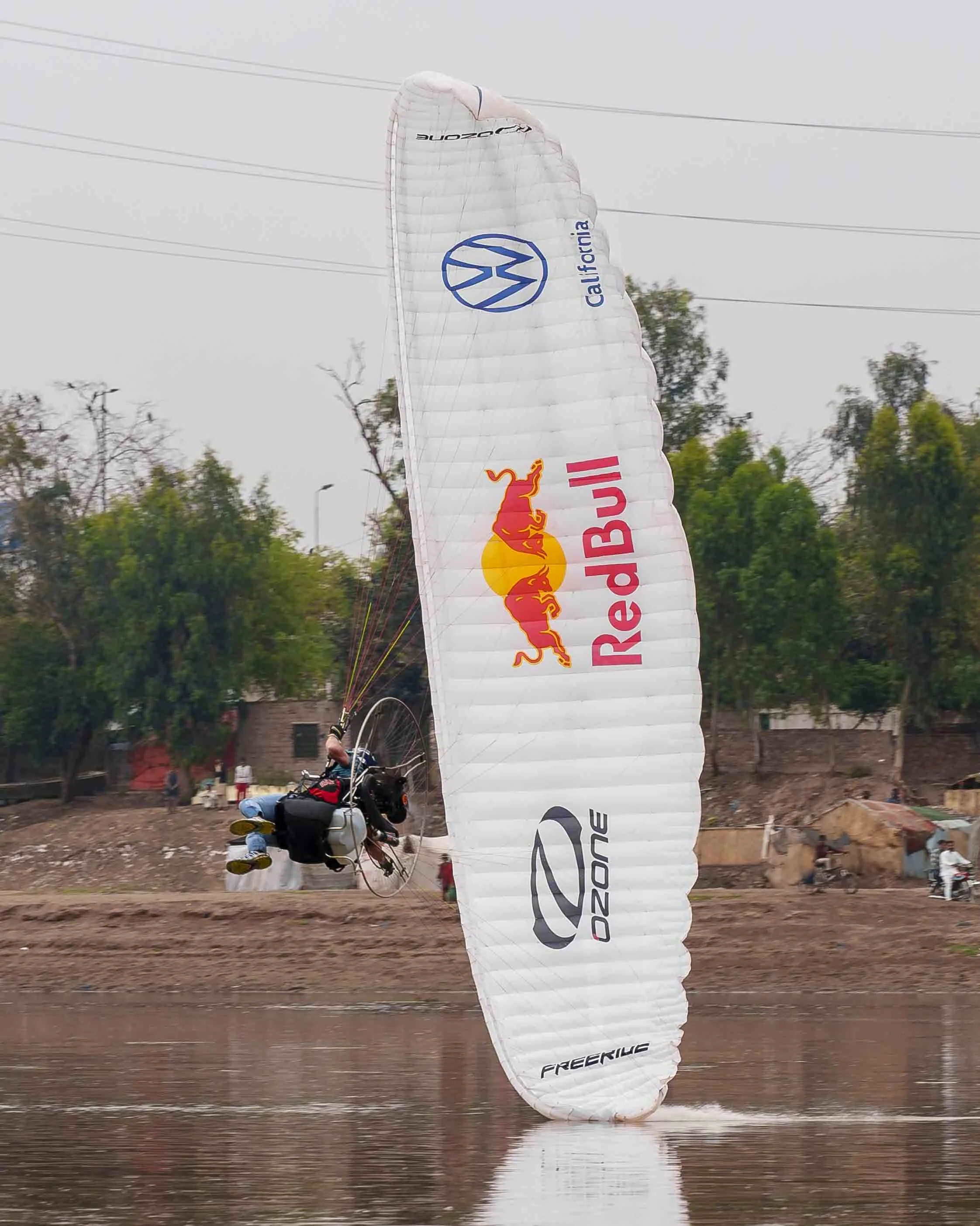 A person riding a powered paraglider. Horacio Lorens in pakistan for Red Bull pakistan for the psl ceremony