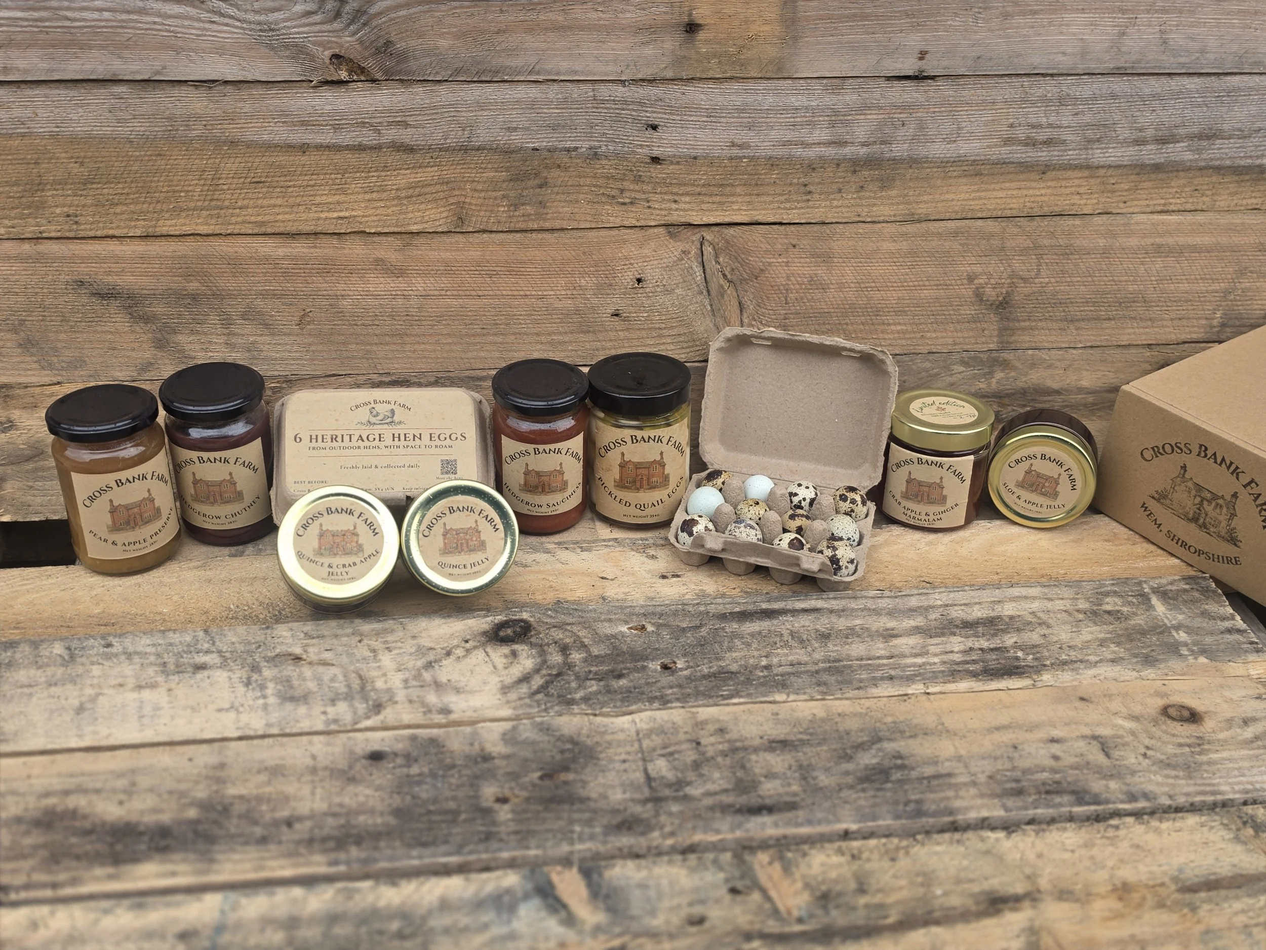 Cross Bank Farm preserves, pickled quail eggs and heritage eggs displayed on a rustic wooden table.