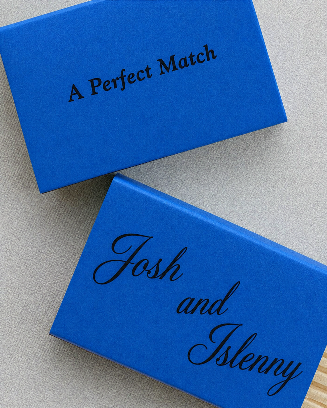 Personalised blue wedding matchbooks printed with the couple’s names and the phrase “A Perfect Match”.