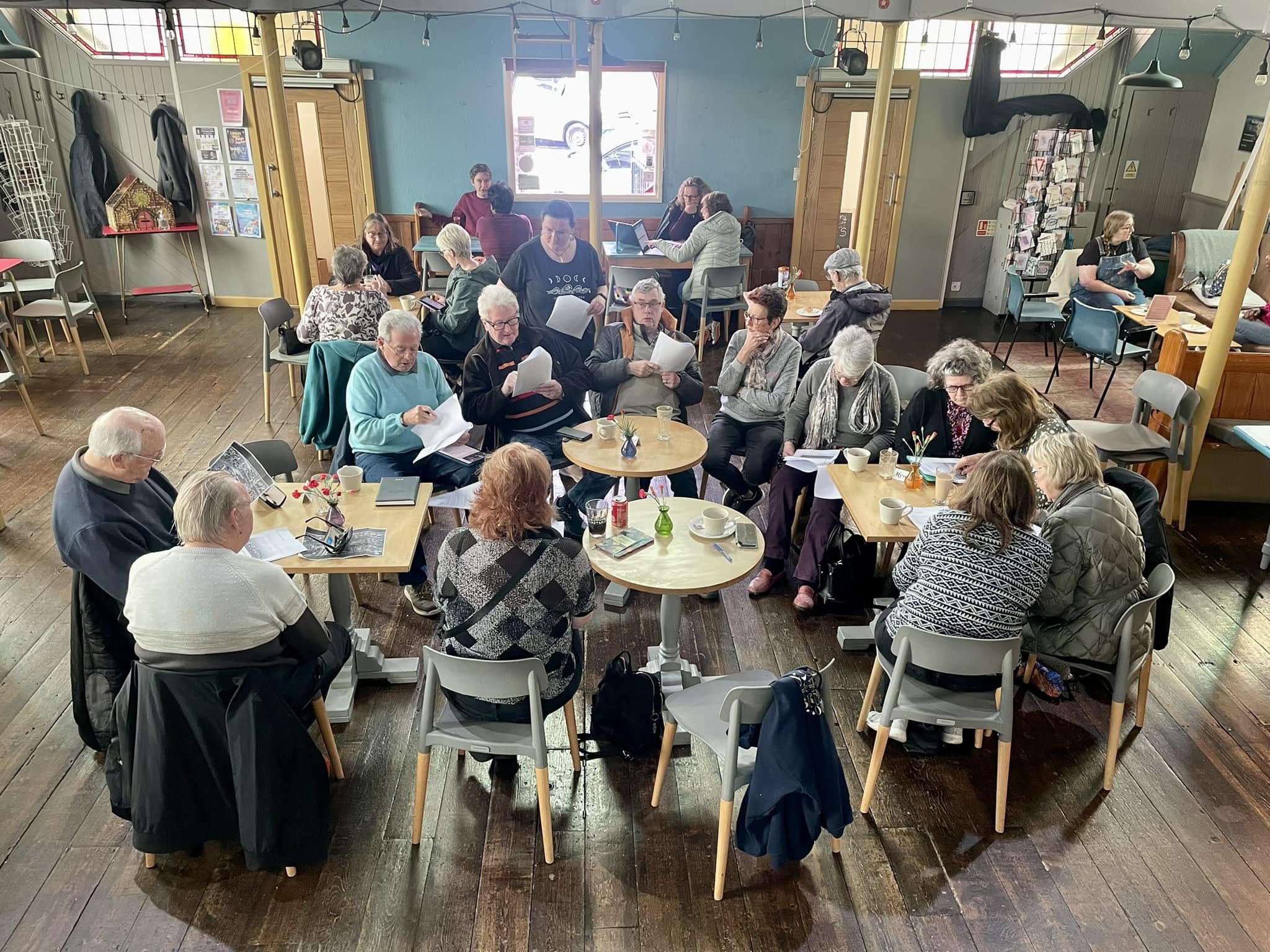 A group of elderly people sat in our community café as part of the local history group.