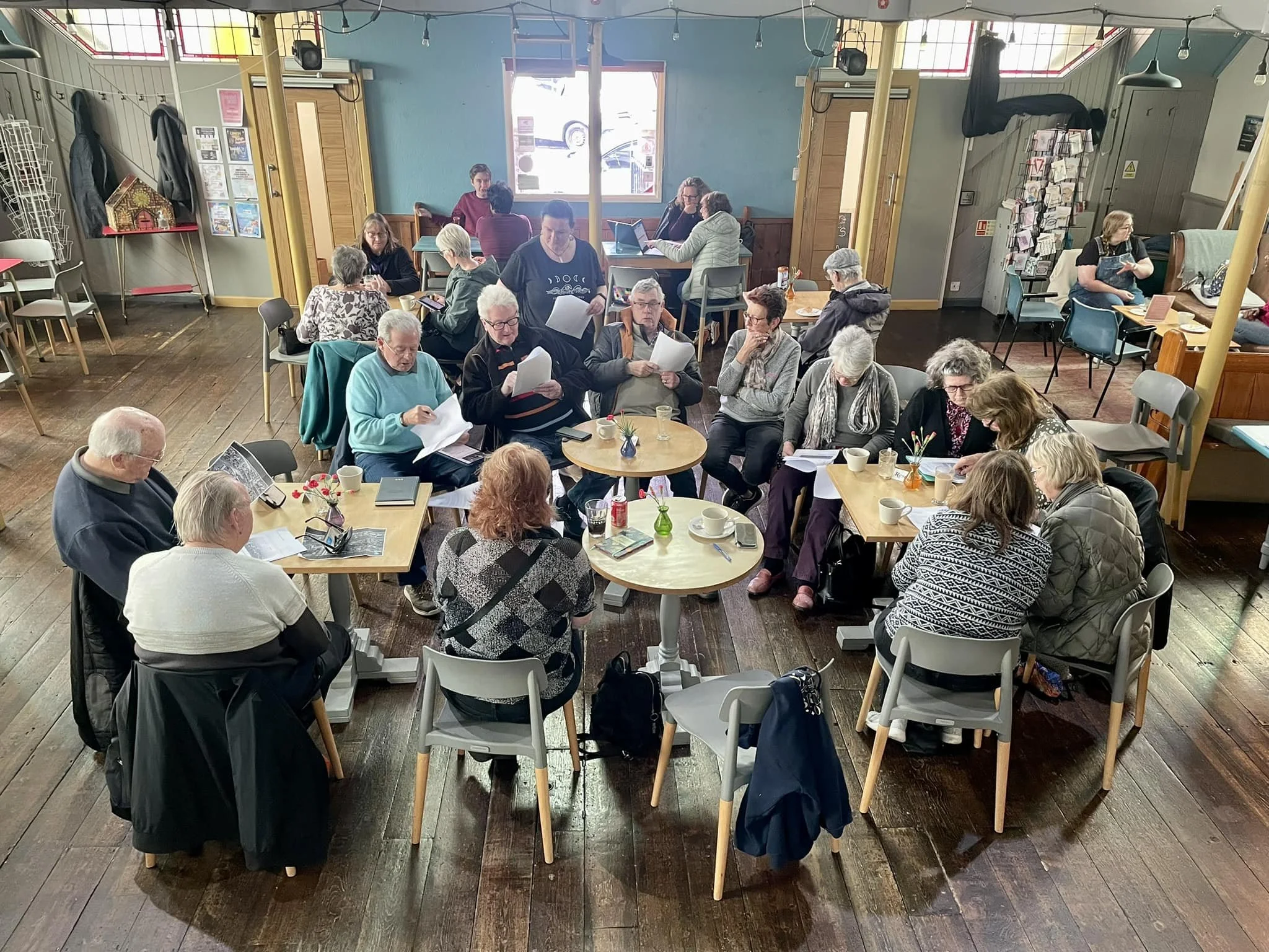 A group of elderly people sat in our community café as part of the local history group.