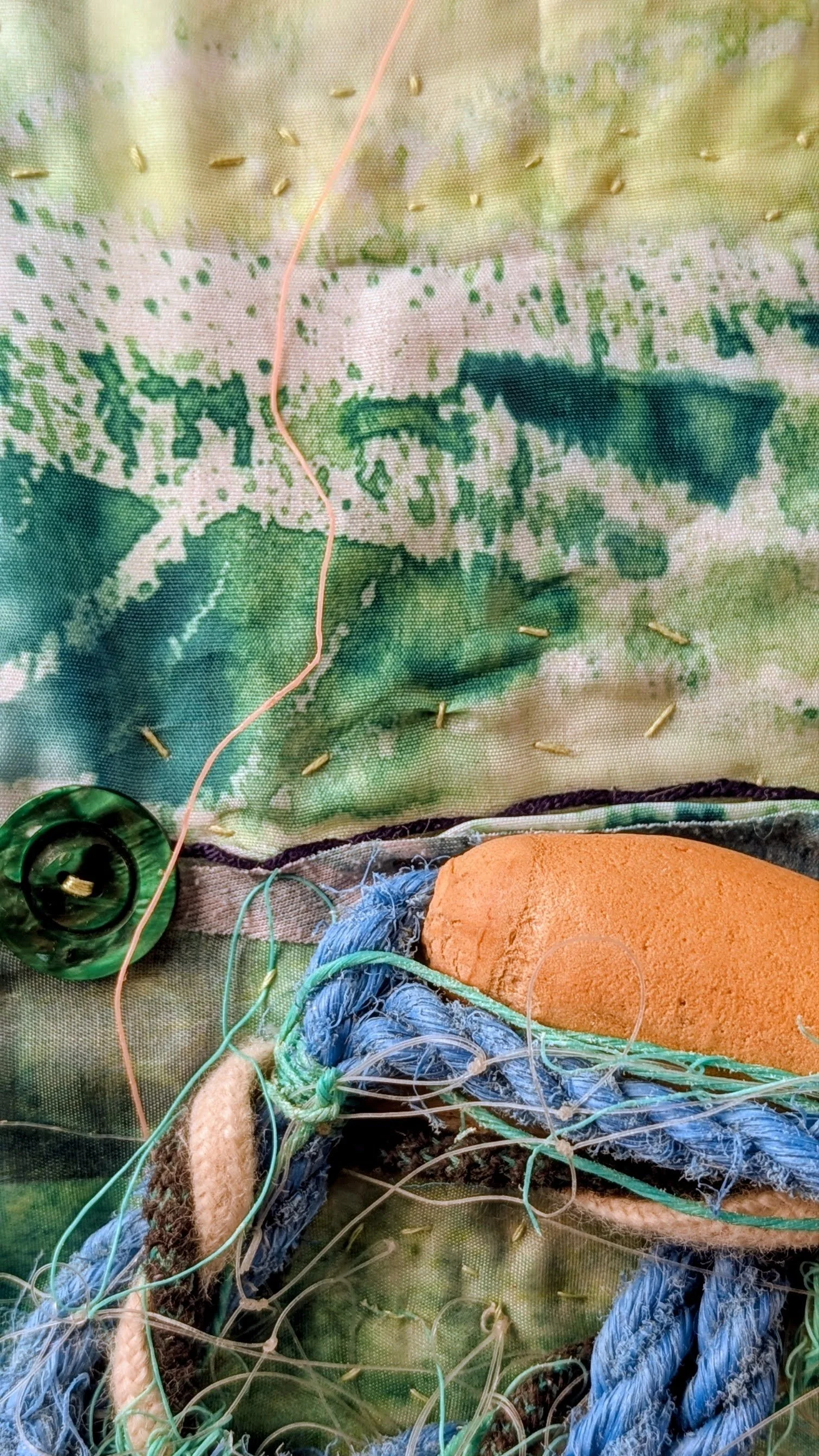 detail of stitches, heat pressed transfer and marine plastics held within Are We Blind? By Lucinda Button