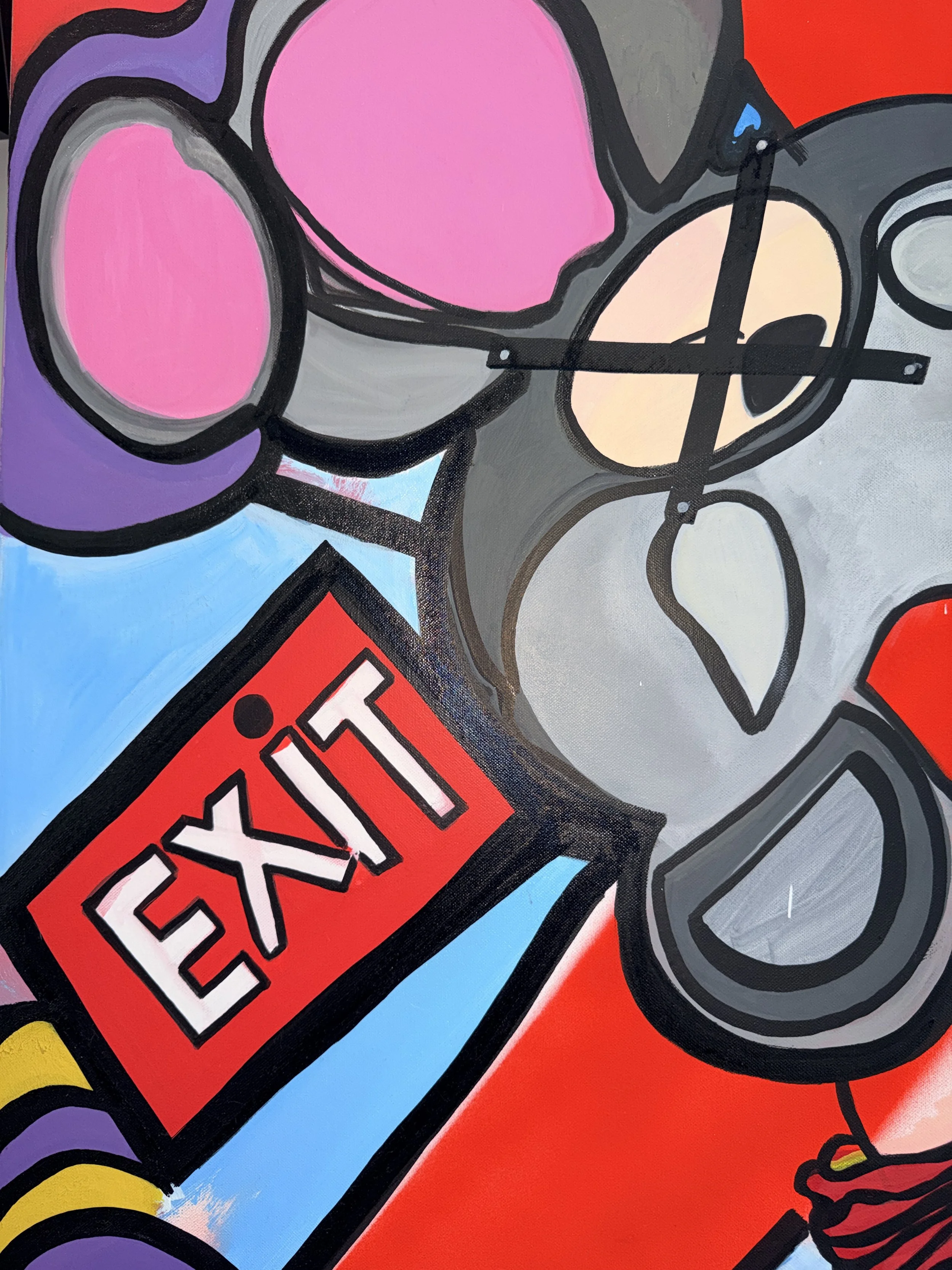 Close-up of a colorful abstract painting featuring large pink, purple, yellow, beige, and red shapes outlined in black, with a prominent red rectangular label that reads 'WARNING' in black letters.