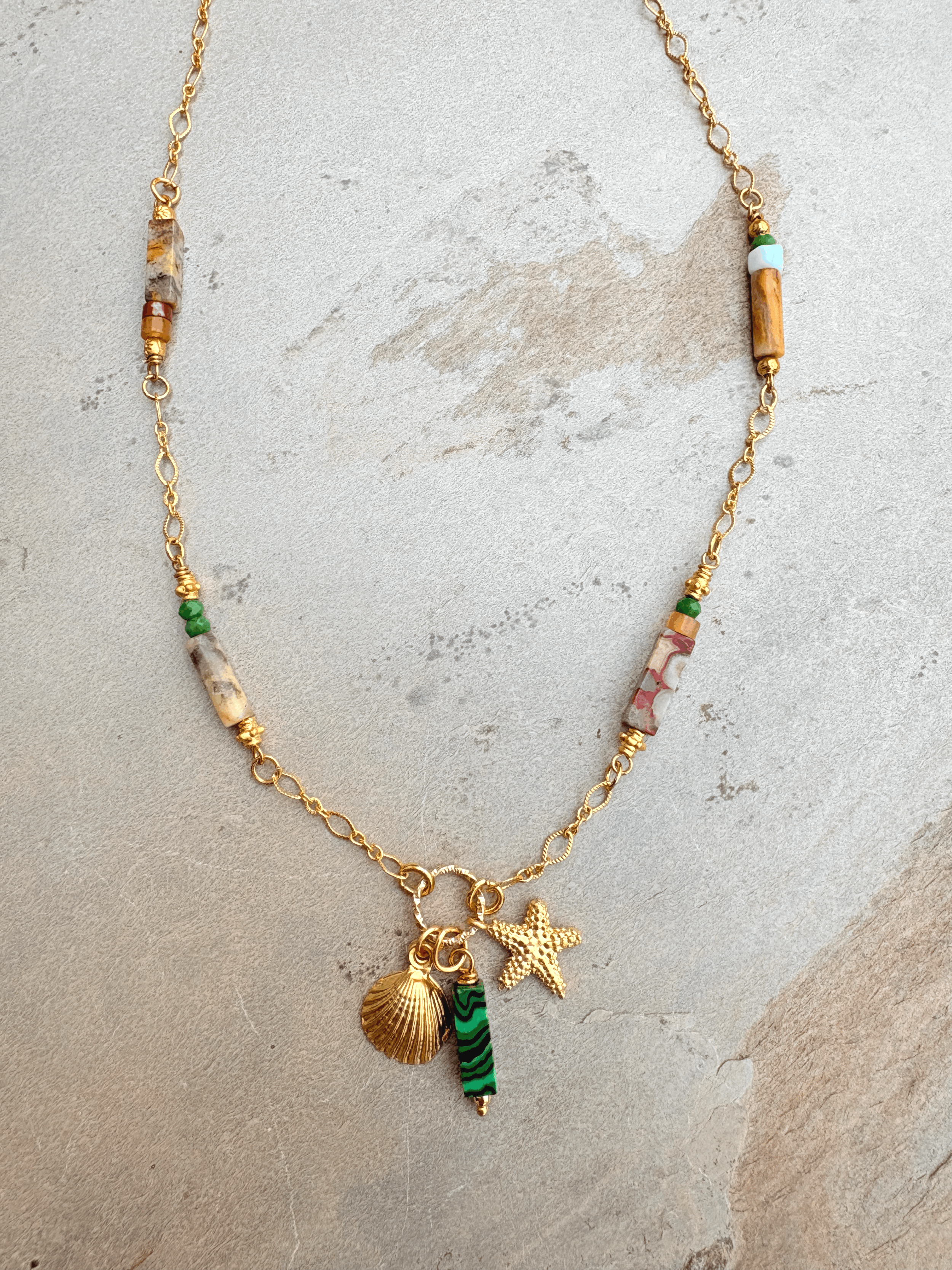 Gold chain and stone necklace with charms