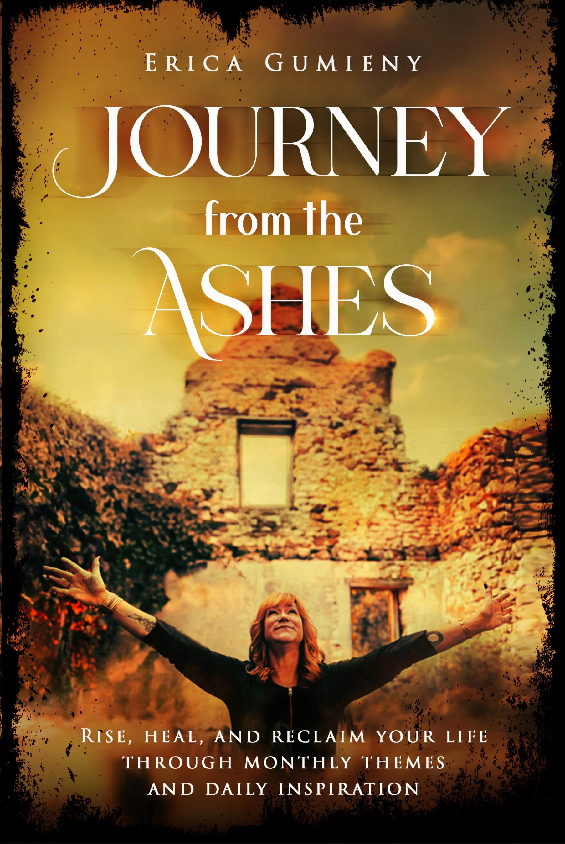 Cover image of a book titled "Journey from the Ashes" by Erica Gumieny. The background features a woman with arms outstretched, standing in front of an ancient stone ruin with an open doorway, under a sky with warm tones. The subtitle reads: "Rise, heal, and reclaim your life through monthly themes and daily inspiration."
