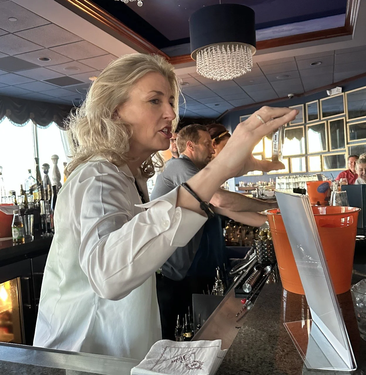 Katrina bartending with big hair and big class1