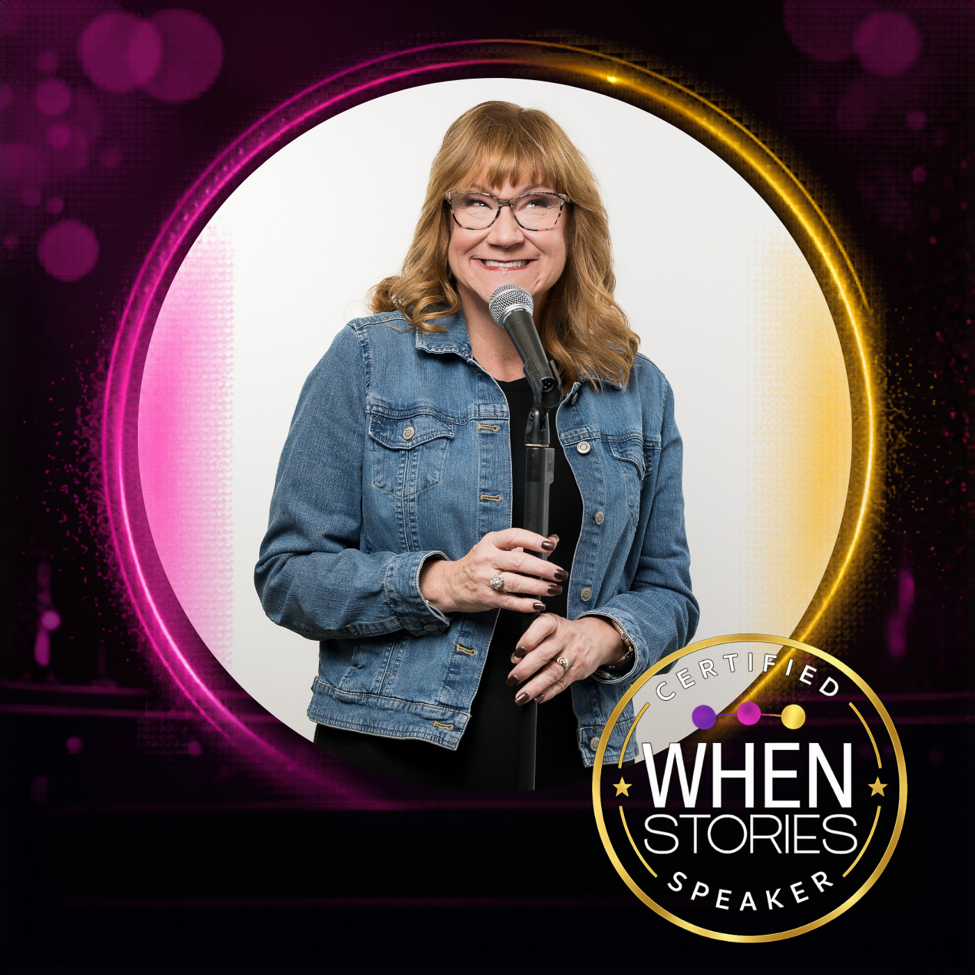 A woman with red hair, glasses, and a denim jacket holding a microphone, smiling, with a white background. The image has a colorful, neon-style circular border and a logo reading 'When Stories Speaker' in the bottom right.