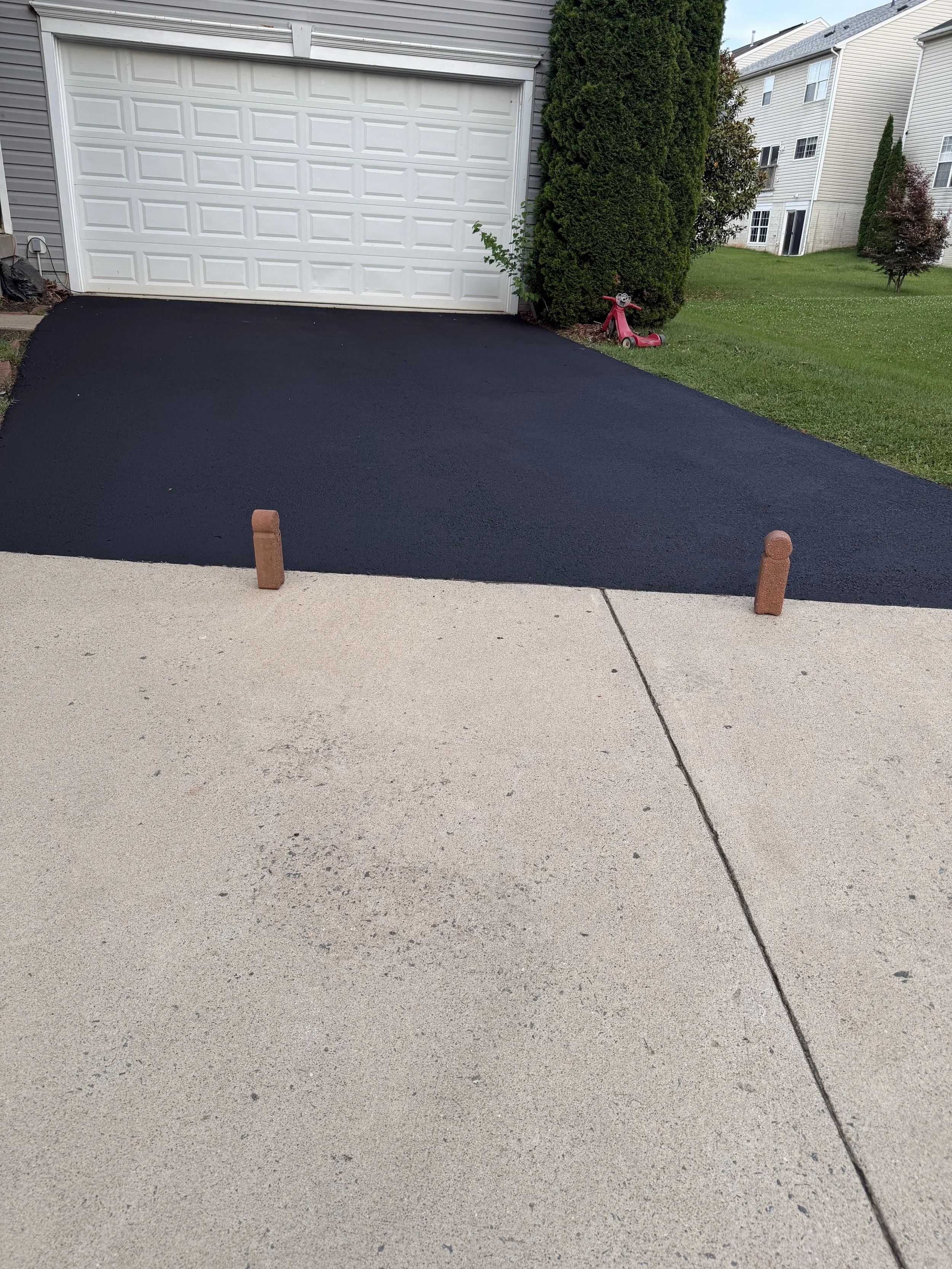 Finished driveway with rich dark finish.