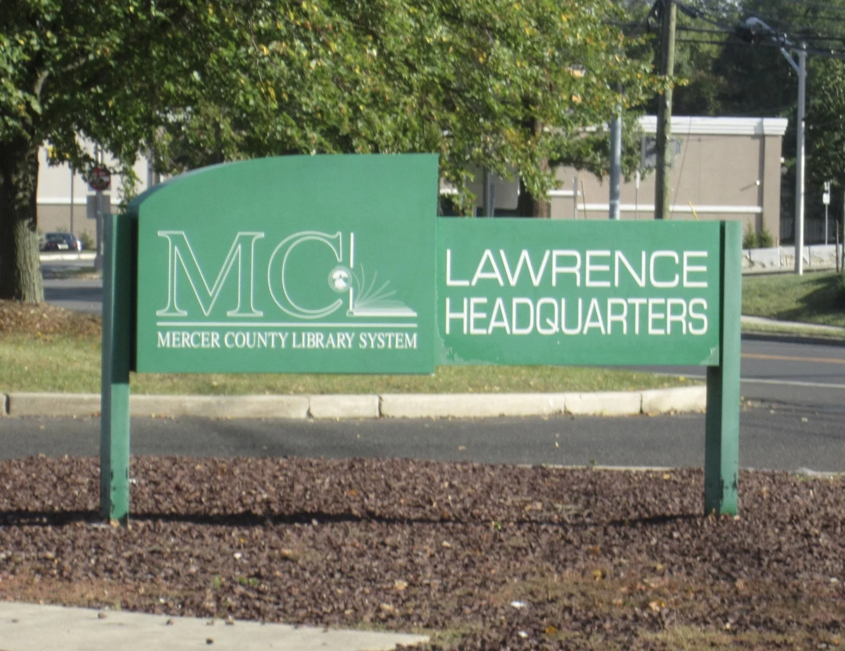 Mercer County Library Lawrence Headquarters green sign in the front of the building
