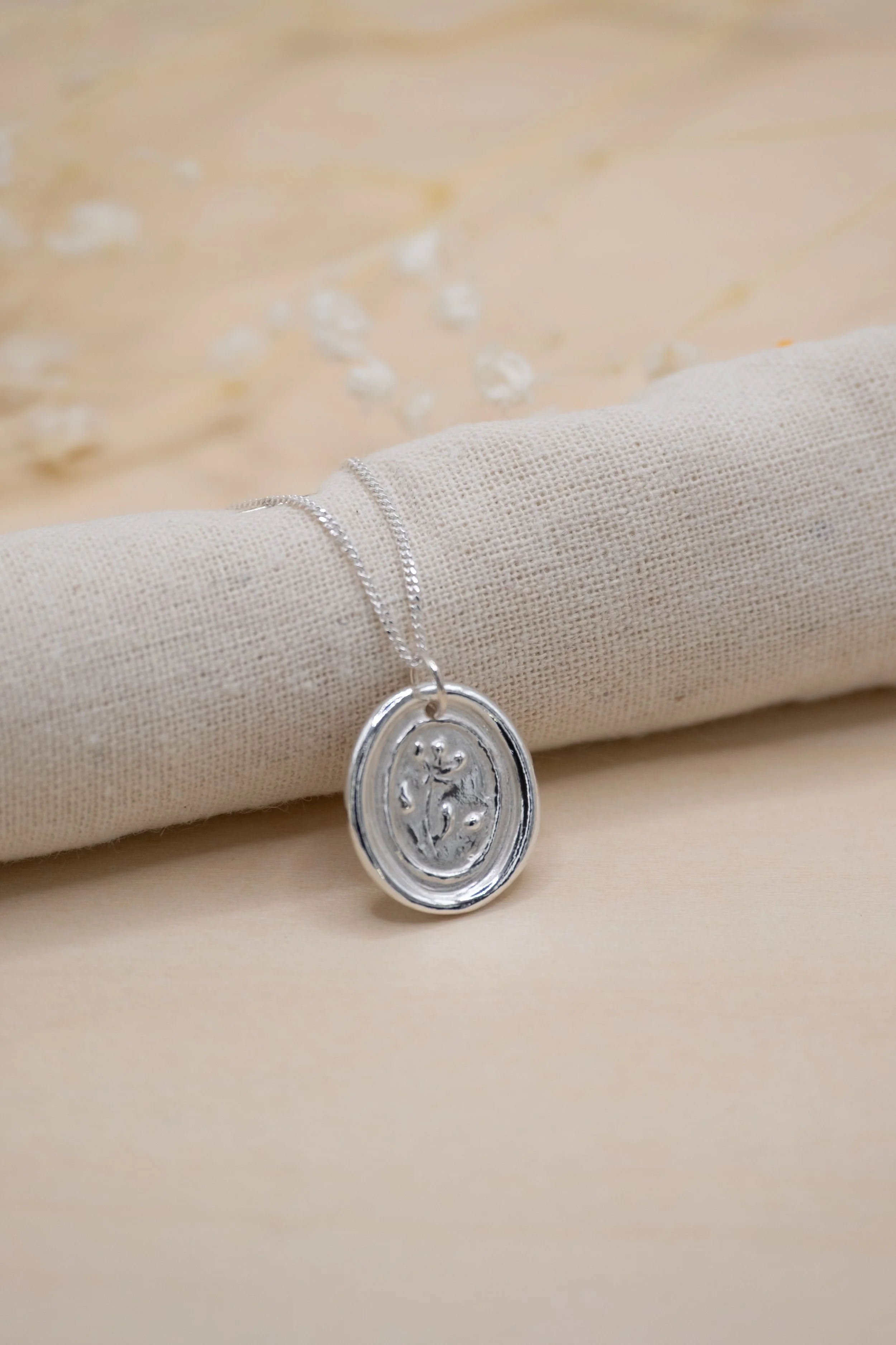 wax seal necklace floral bg retouched.jpg