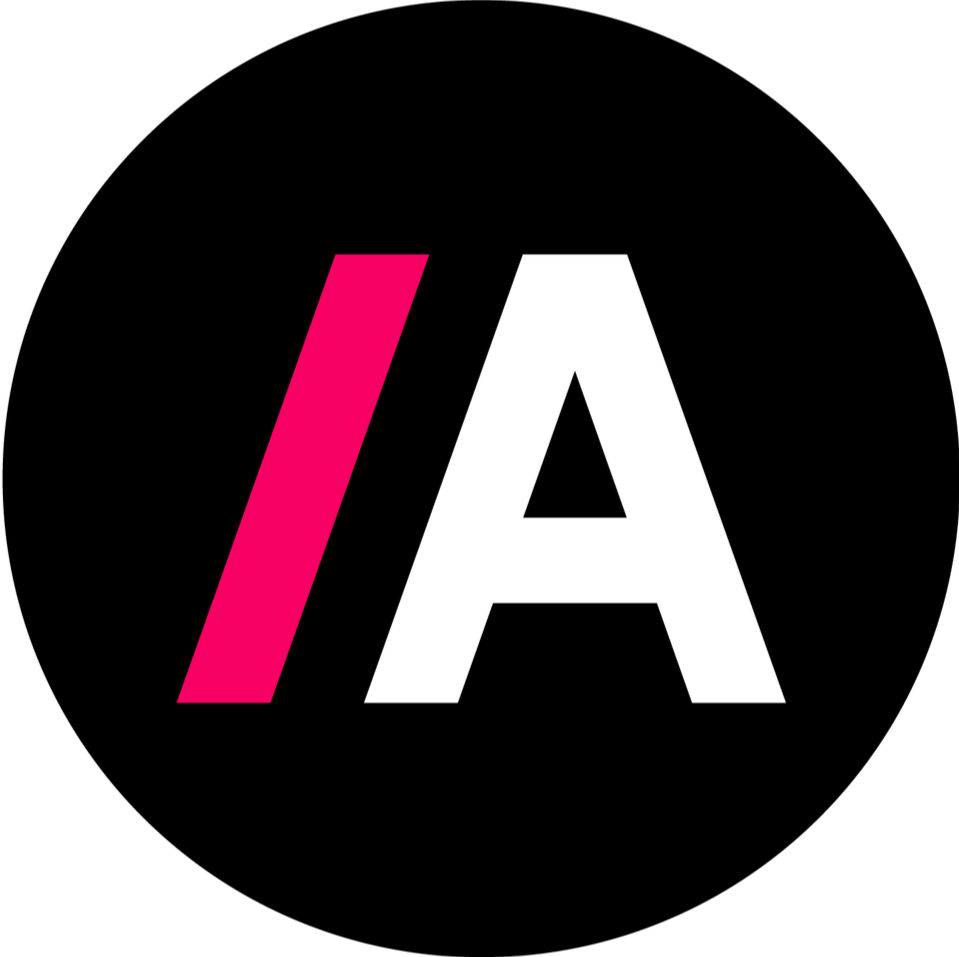 A stylized logo with a black background, featuring a pink forward slash, a white capital letter 'A', and the words 'AD' in white.
