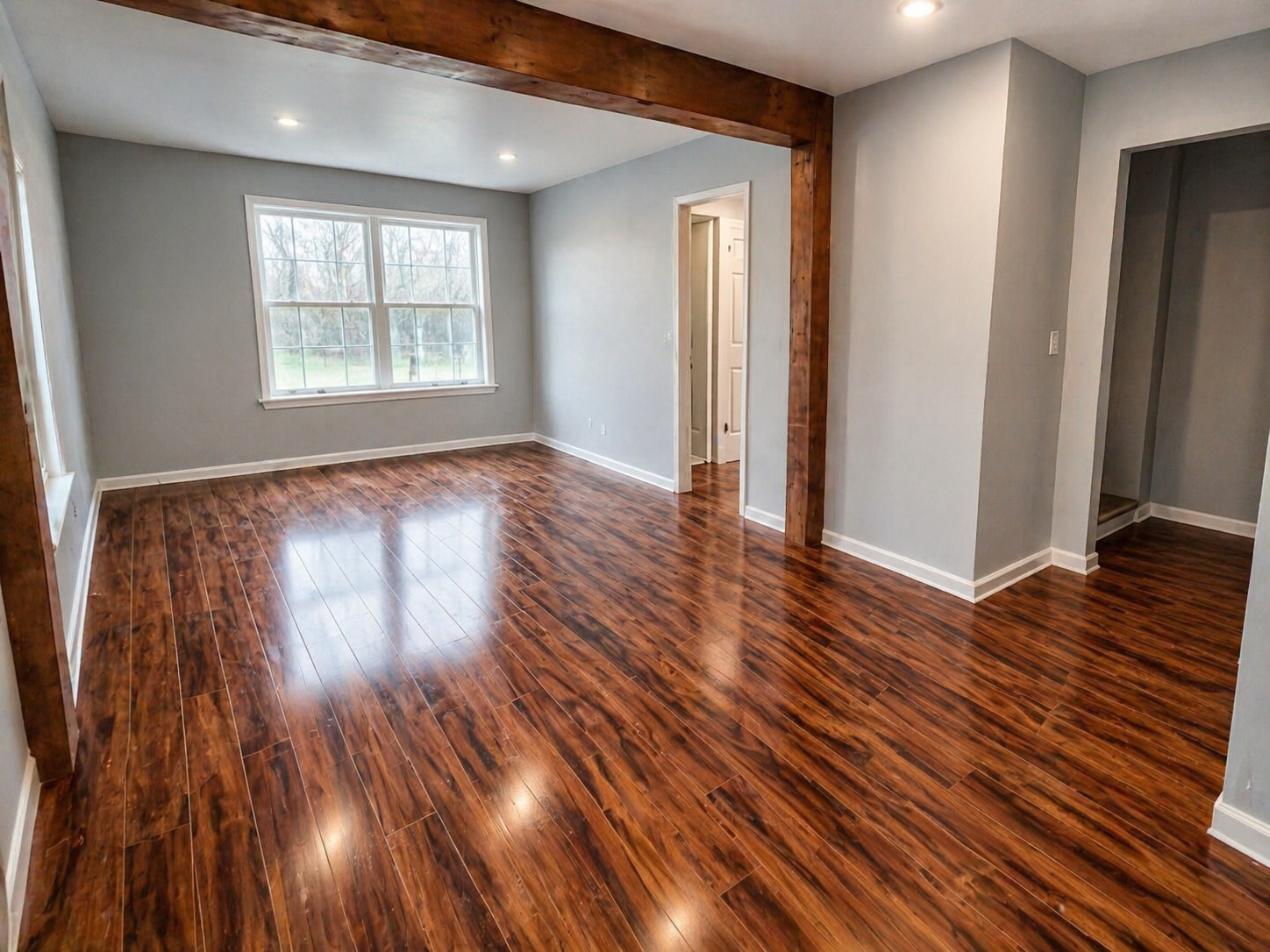 his transformed living space features updated flooring, refreshed walls, and a more finished, cohesive look throughout. The wide-open layout offers flexibility for everyday living, entertaining, or creating a multi-purpose family space. Large windows