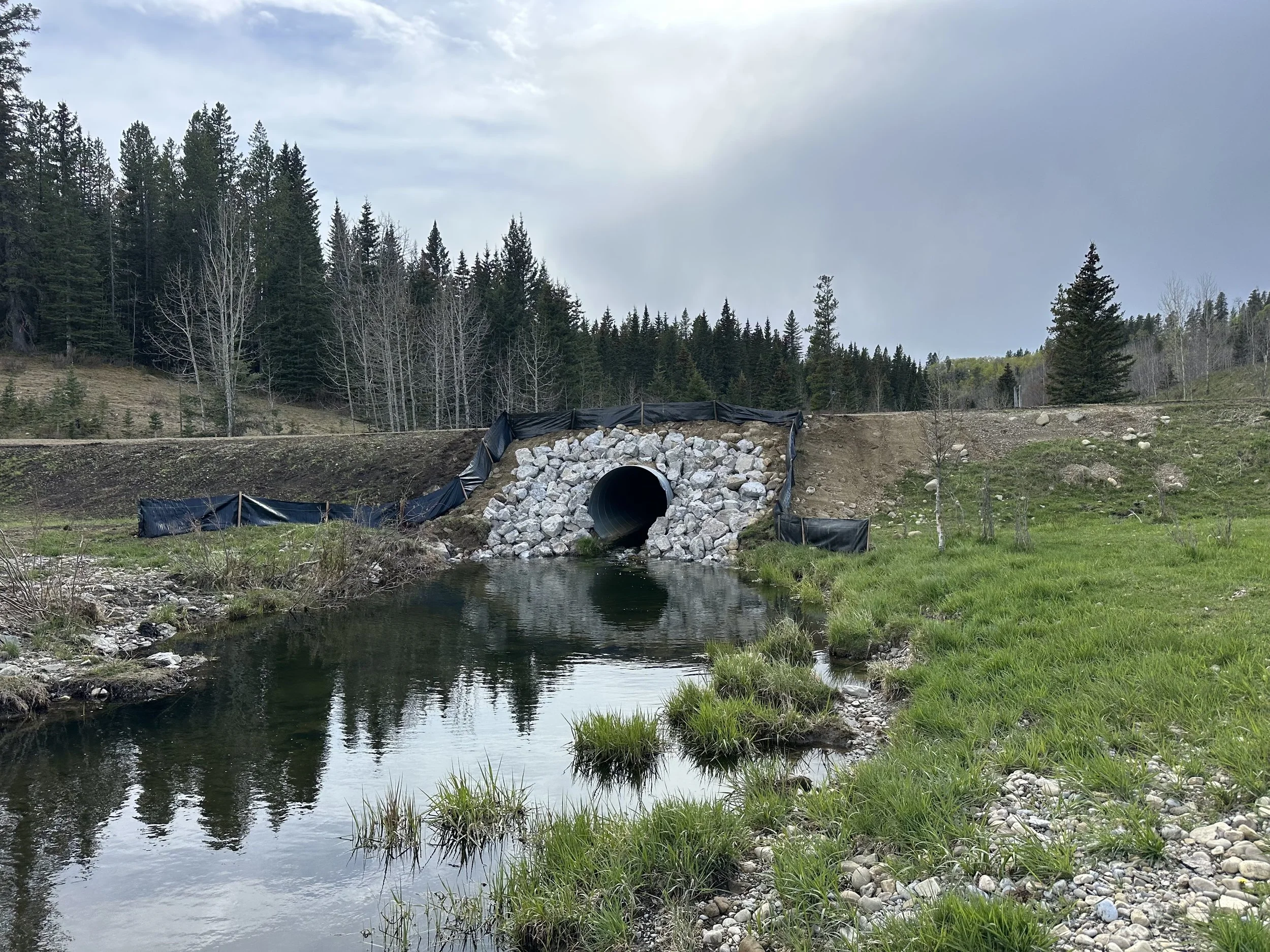 Rip rap armouring installation for erosion control and slope stabilization in Alberta