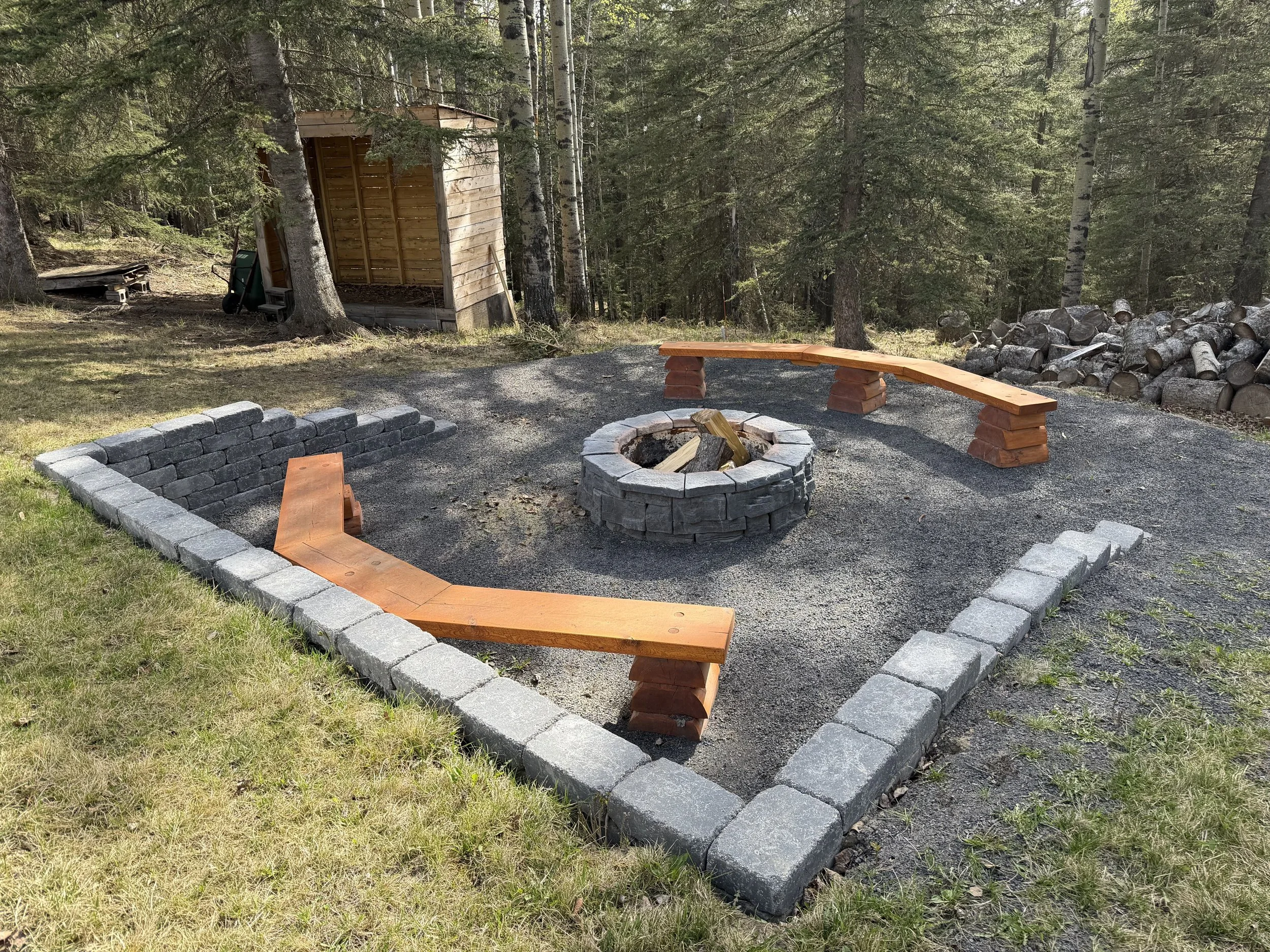 Gravel fire pit area and landscape grading completed on a rural acreage property.