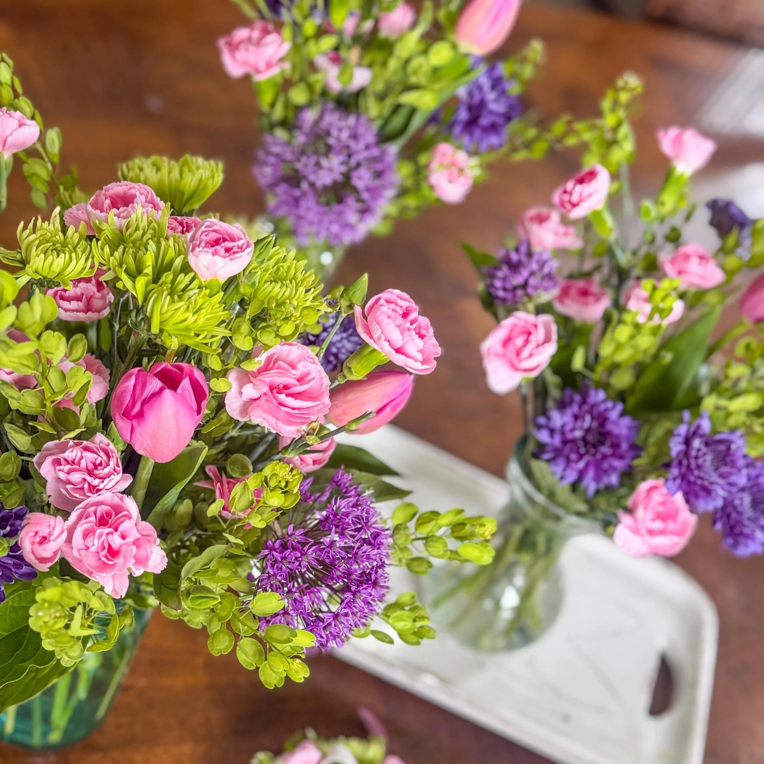 Soft blues, playful pinks, fresh spring greens, and touches of purple made this gender reveal floral project such a fun one to bring to life 💙💗💜🌿 From the centerpieces to the corsage, I was so honored to be a part of such a special celebration an