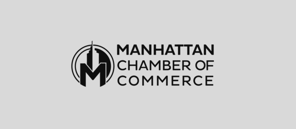 Logo of Manhattan Chamber of Commerce featuring a stylized building and the text 'Manhattan Chamber of Commerce'.