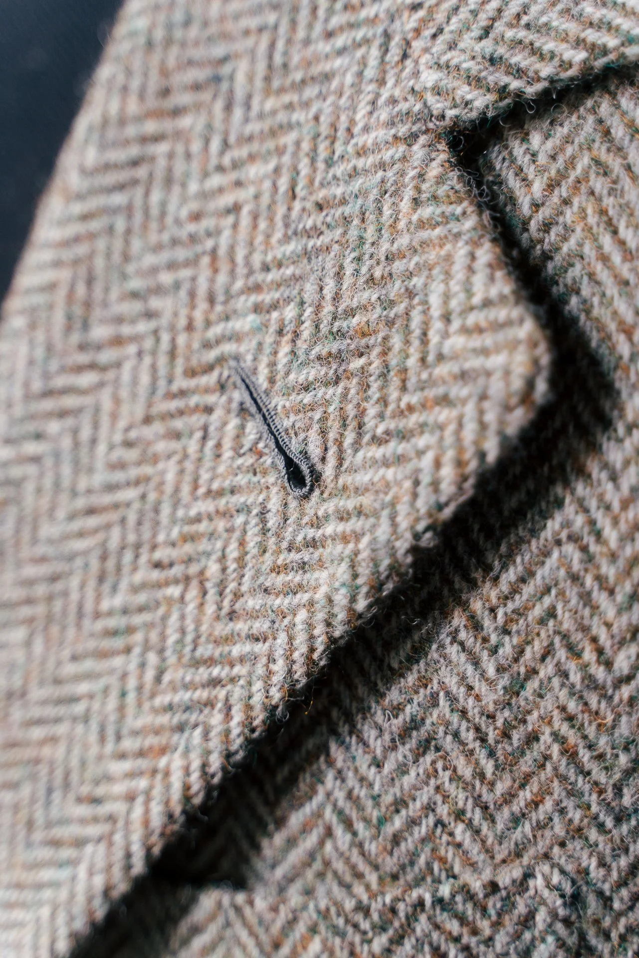 Close-up of a brown woven fabric with a small zipper pocket.