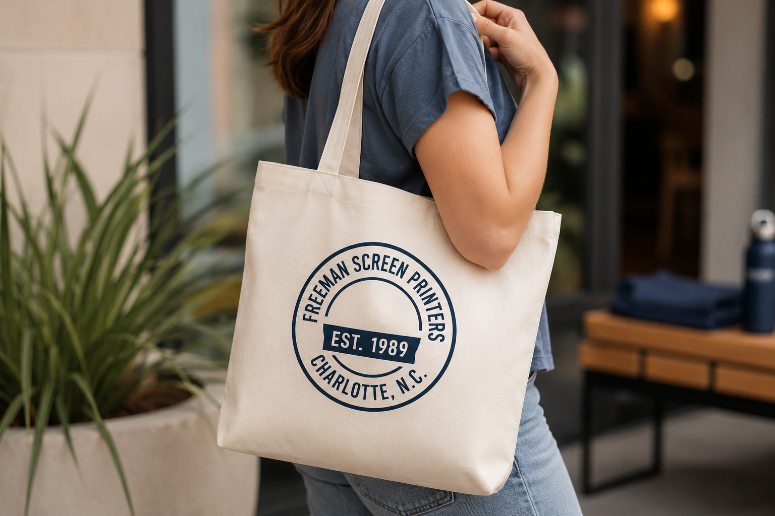 Person carrying a custom screen printed canvas tote bag with a printed logo for promotional products, schools, organizations, events, and businesses.